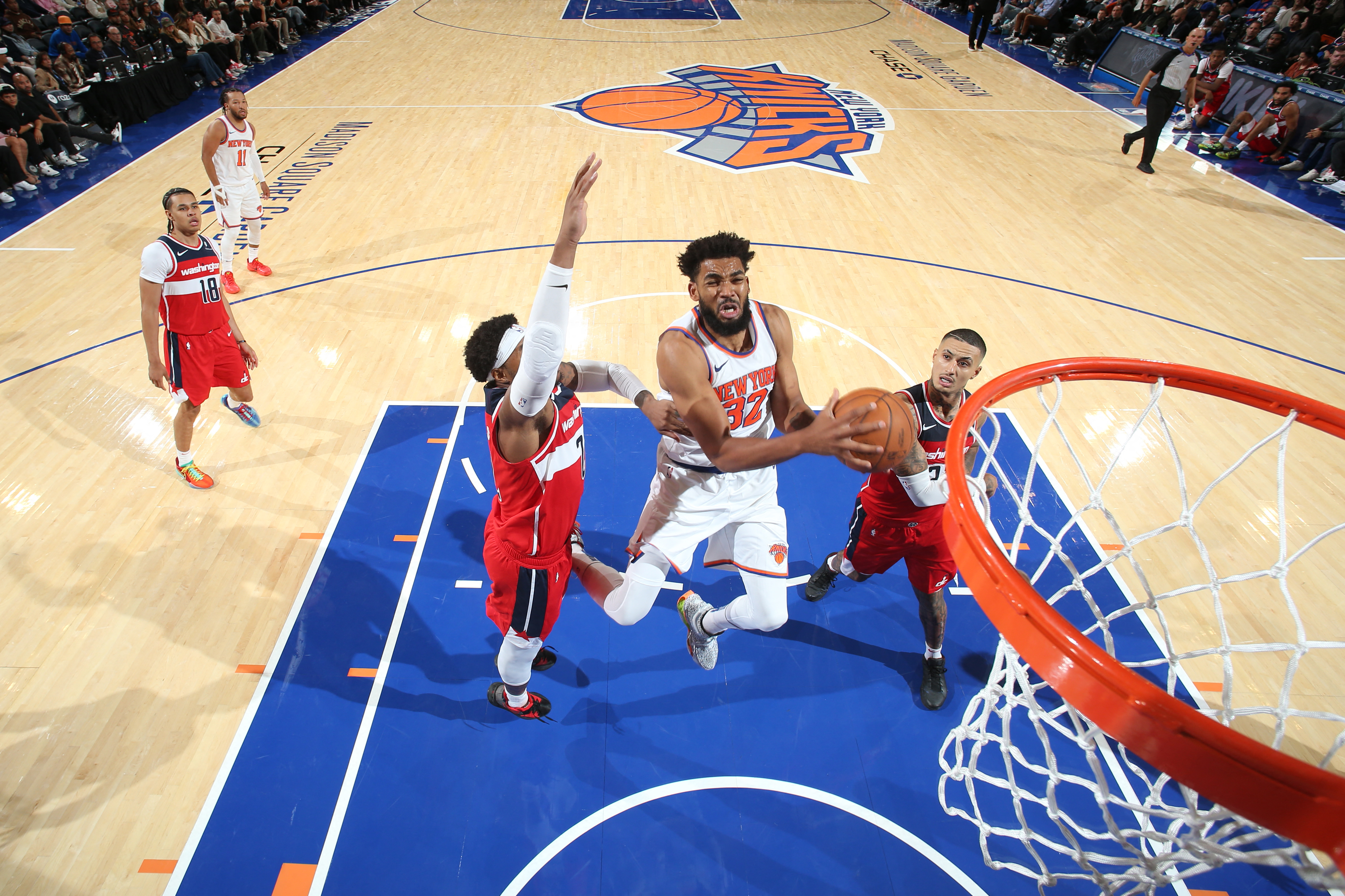 NBA player drives towards basket.