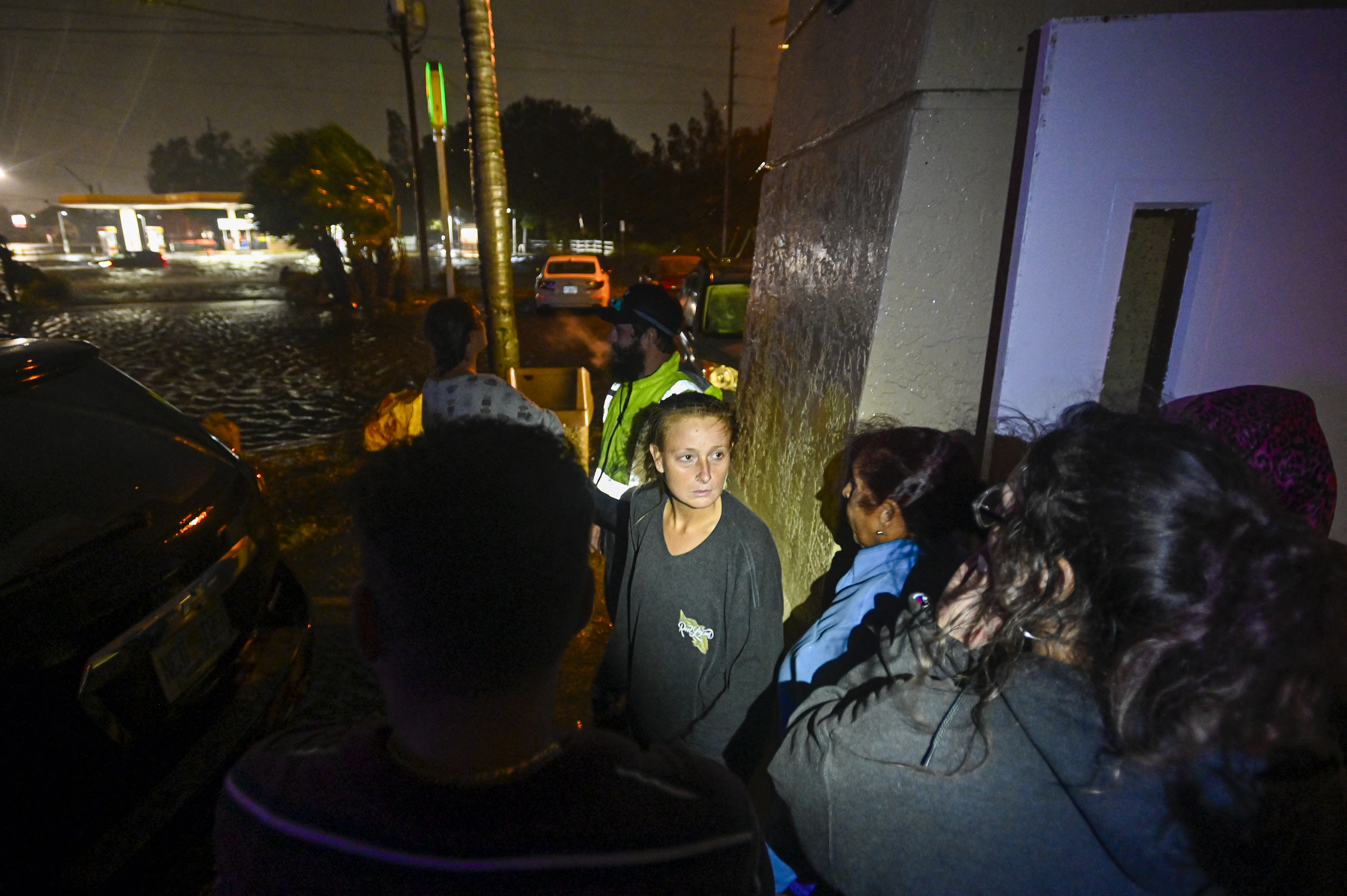People watch water-flooded streets after Hurricane Milton made landfall in Brandon, Florida on October 9, 2024.