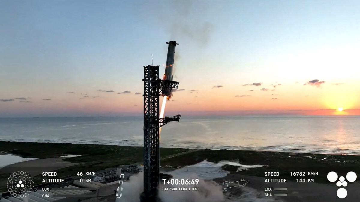 This still image taken from a SpaceX broadcast shows the Starship's Super Heavy Booster being grappled midair as it returns to the launchpad at Starbase near Boca Chica, Texas.