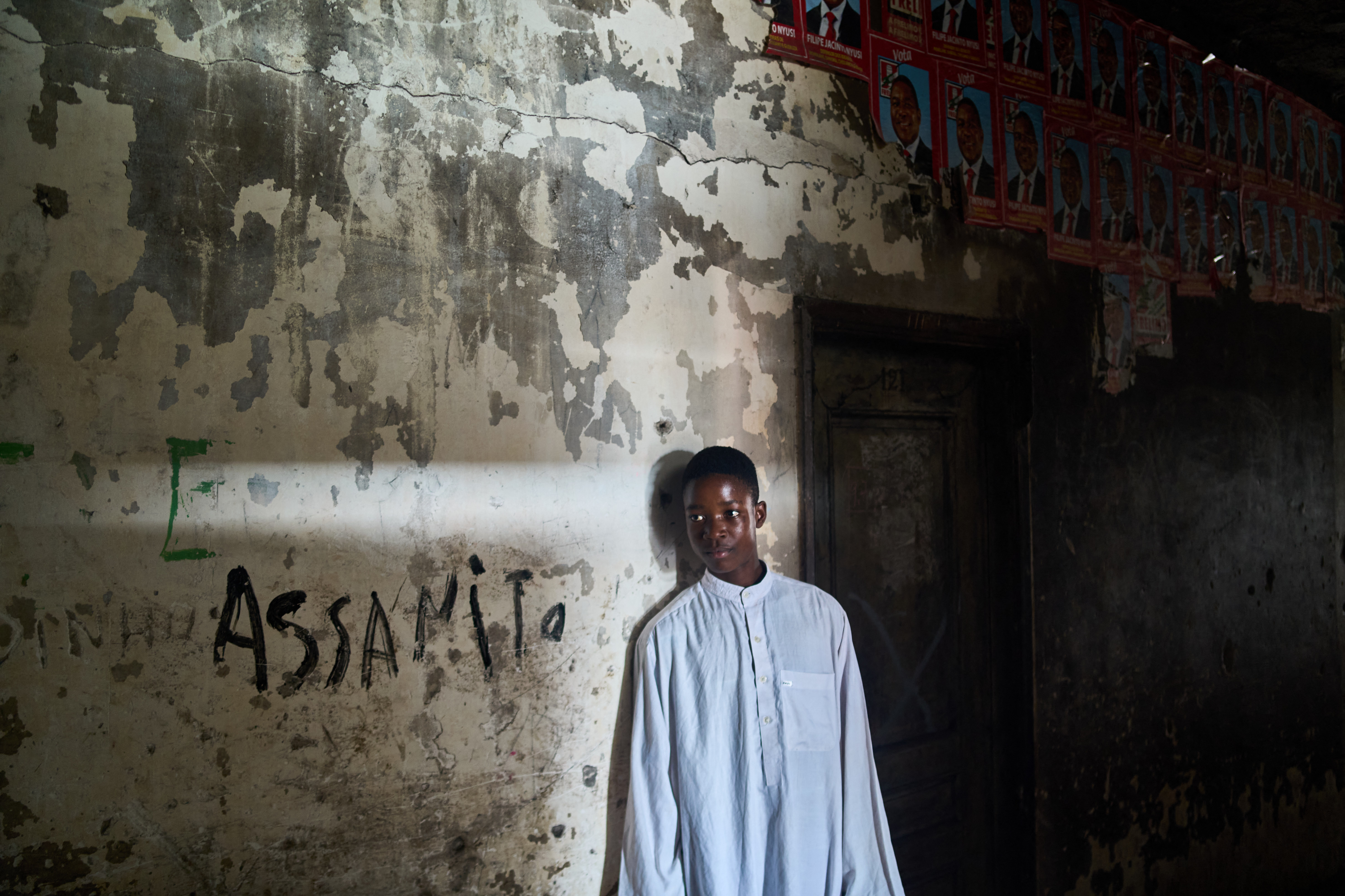 Hasanido Arcancu, a teenage football enthusiast dreams of becoming a professional player, poses for portrait in the the Grande Hotel in Beira on October 12
