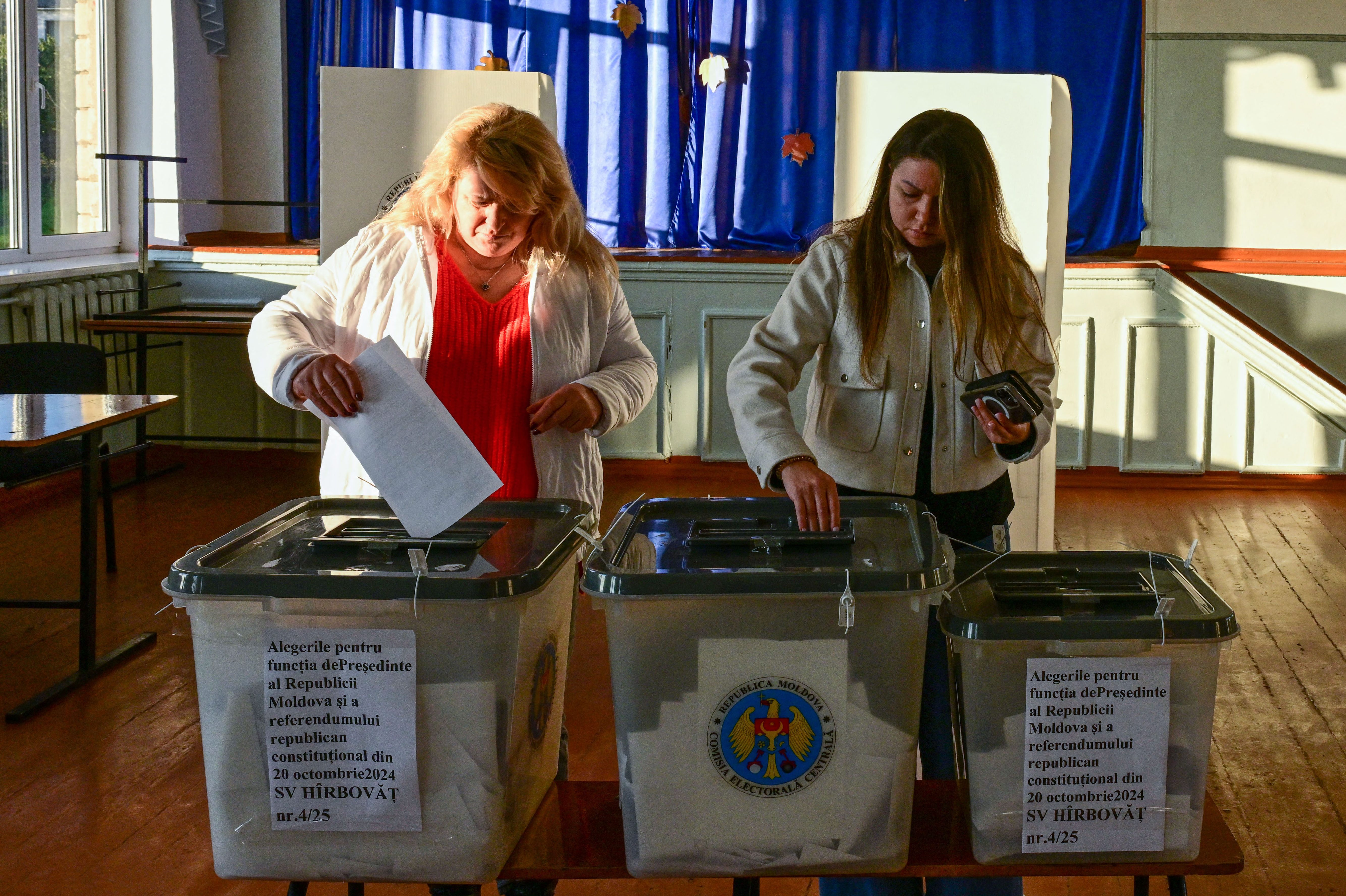 Two women vote during the presidential elections