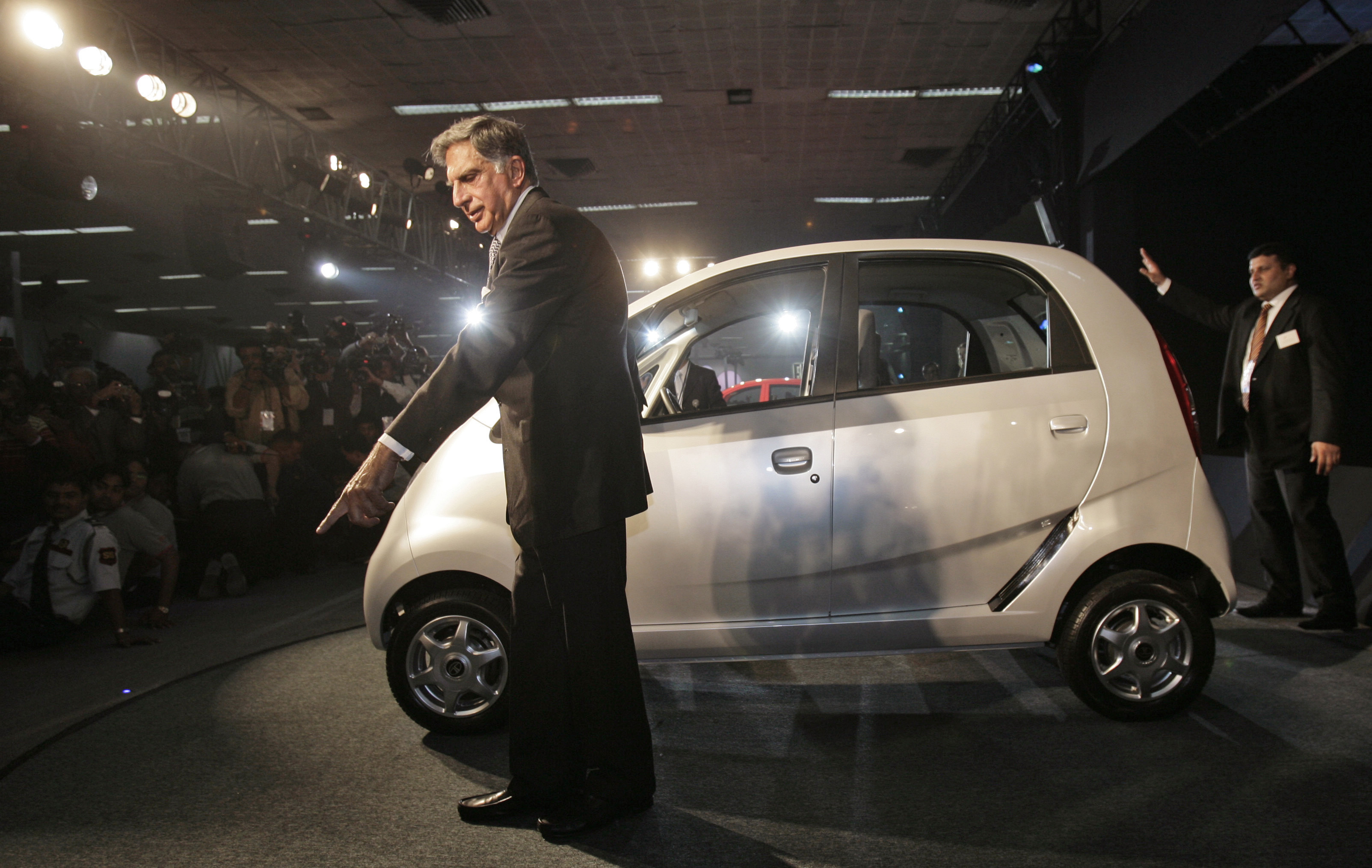 Tata Company Chairman Ratan Tata gestures during the launch of Tata Nano at the 9th Auto Expo in New Delhi, India