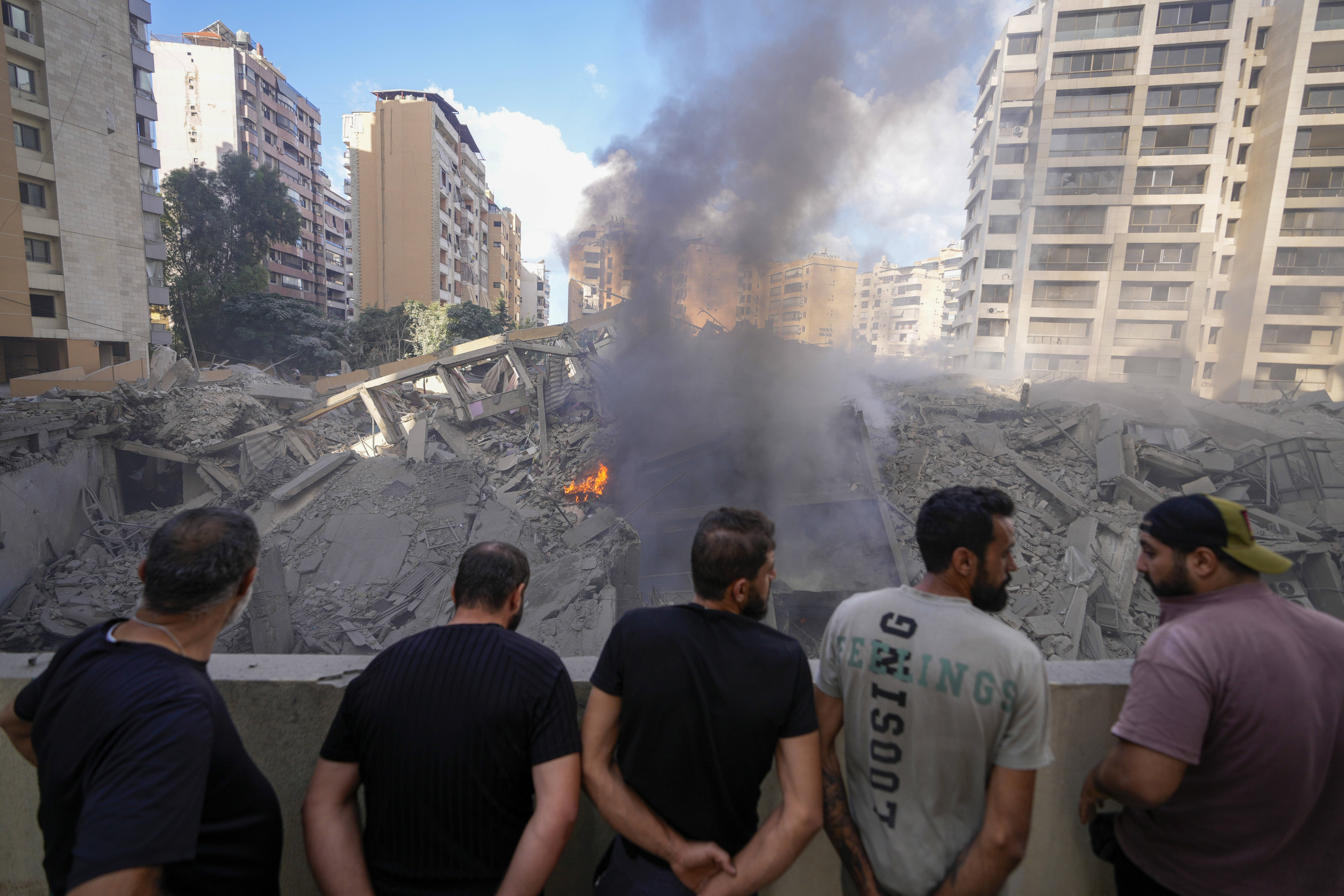 People check the site of an Israeli airstrike in Dahiyeh, Beirut, Lebanon, Wednesday