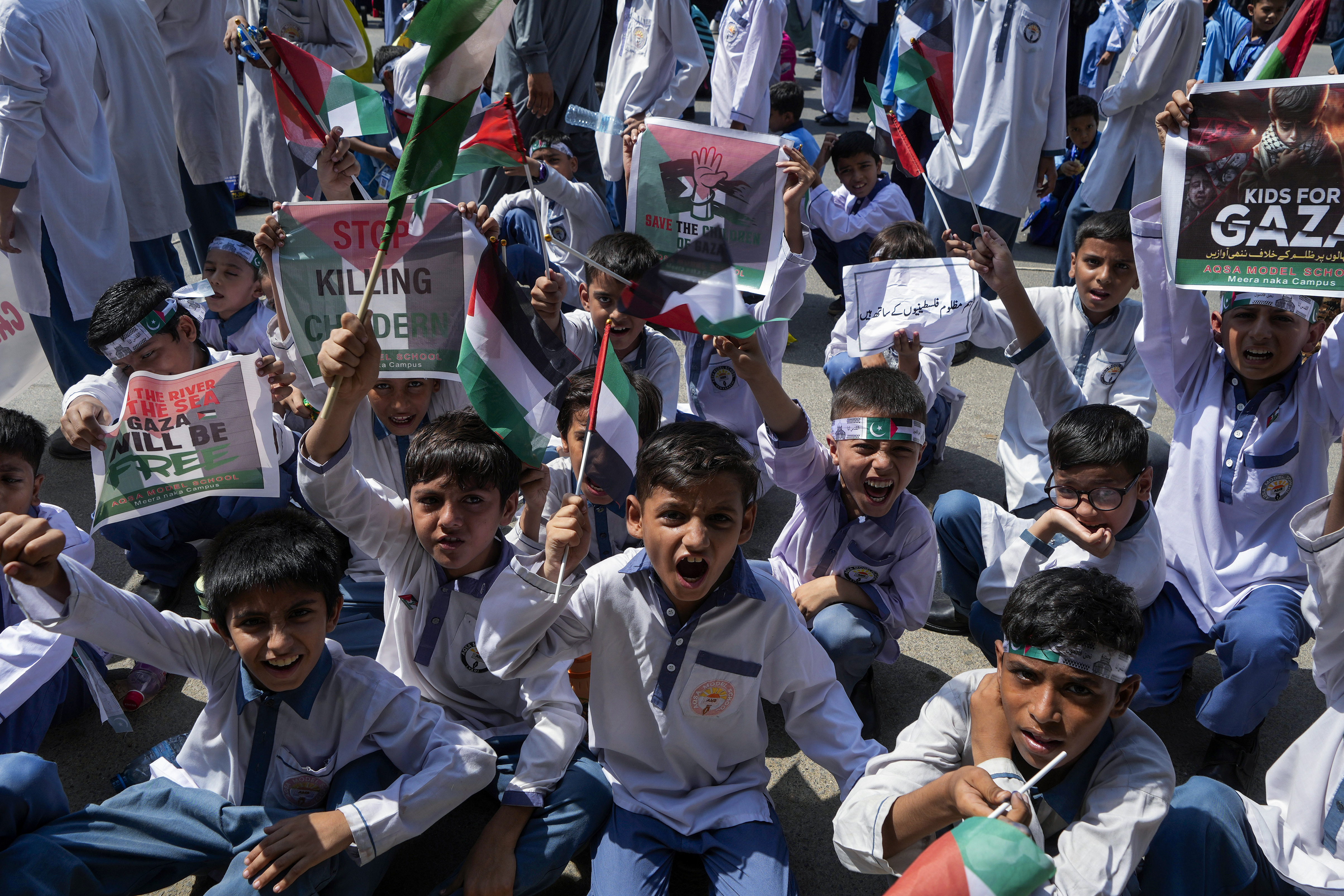 School children take part in a rally to protest Israel's genocide against Palestinians in Gaza, in Karachi