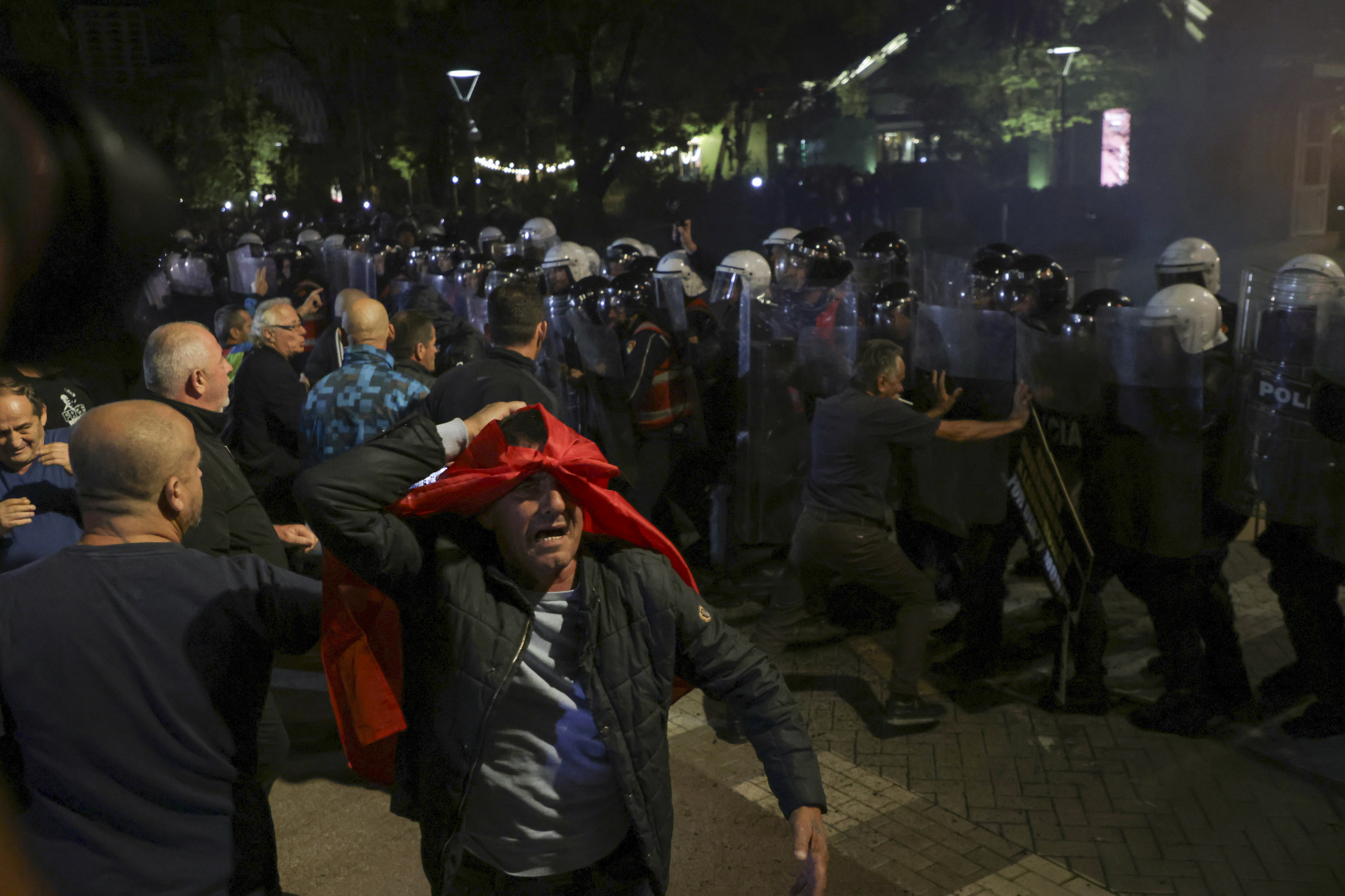 Opposition supporters scuffle with riot police during a anti-government rally, in Tirana, Albania, Monday, Oct. 7