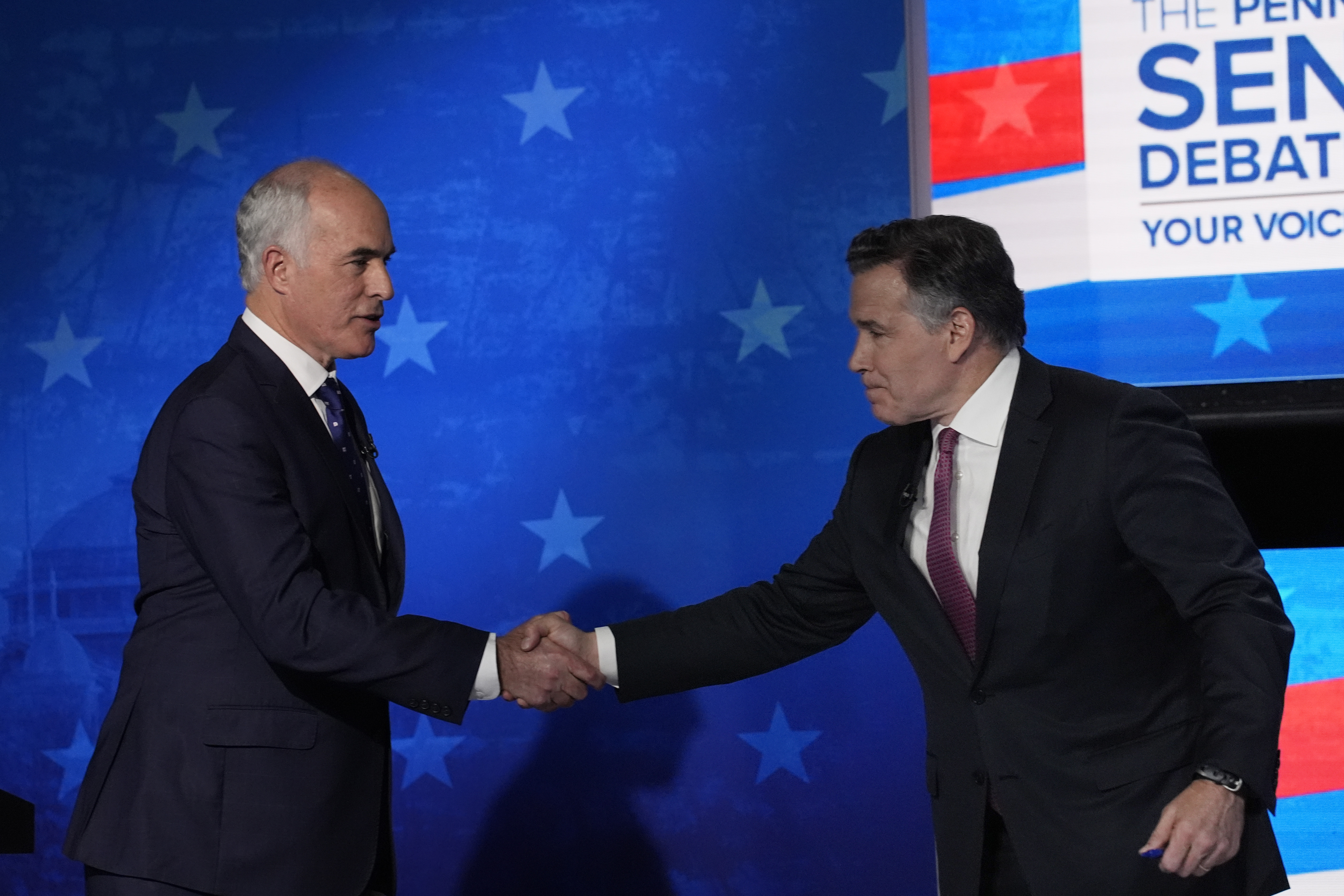 Bob Casey shakes hands with David McCormick on the debate stage in October 2024