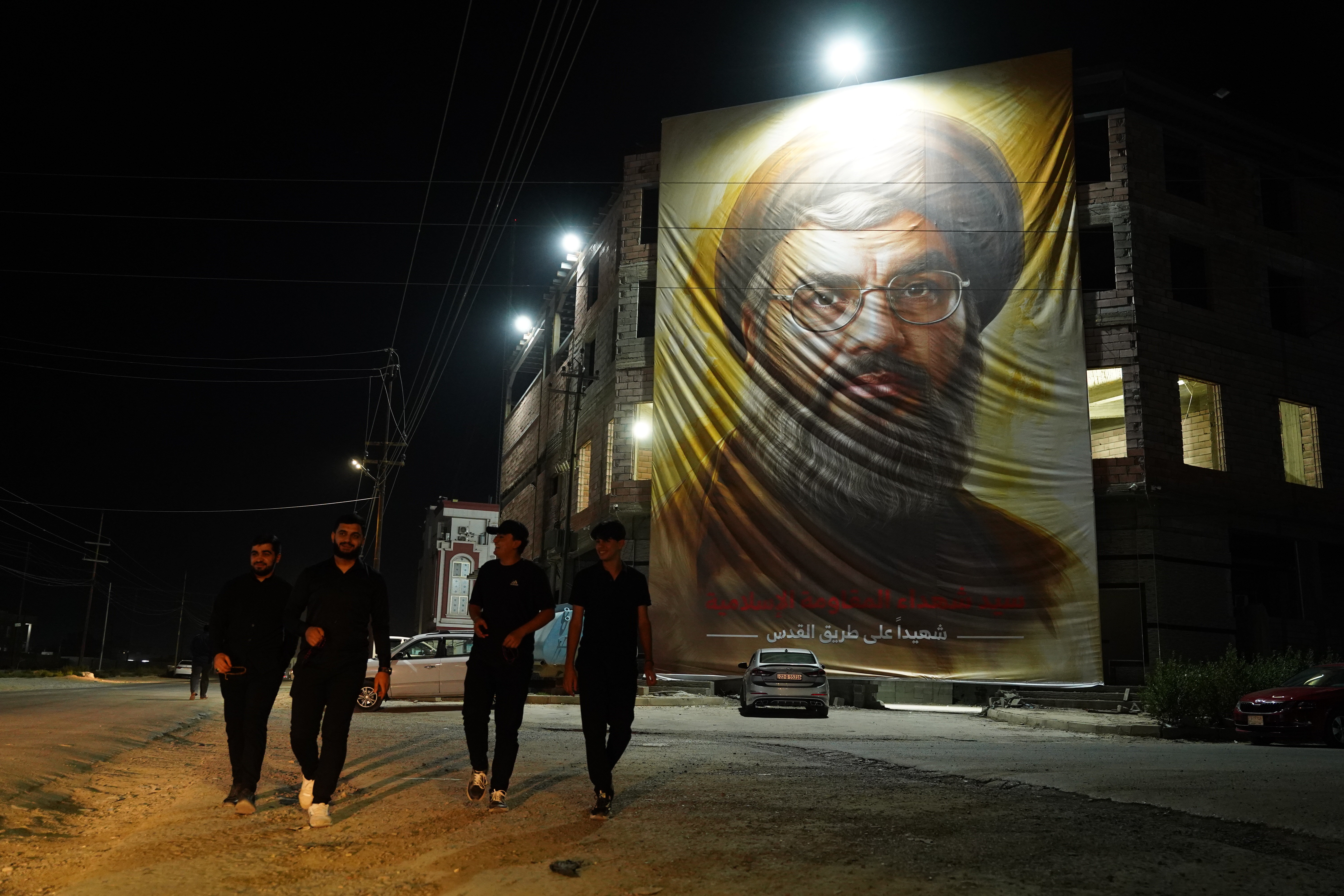 A fabric portrait of late Hezbollah leader Hussein Nasrallah, who was killed in Beirut in an Israeli strike on Friday, is seen on the facade of a four story building in the village of Khazna, east of Mosul [Al Jazeera]