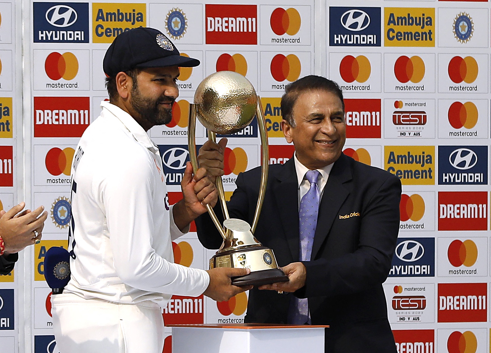 Cricket - Fourth Test - India v Australia - Narendra Modi Stadium, Ahmedabad, India - March 13, 2023 India's Rohit Sharma receives the Border Gavaskar trophy from Sunil Gavaskar after winning the test series REUTERS/Amit Dave