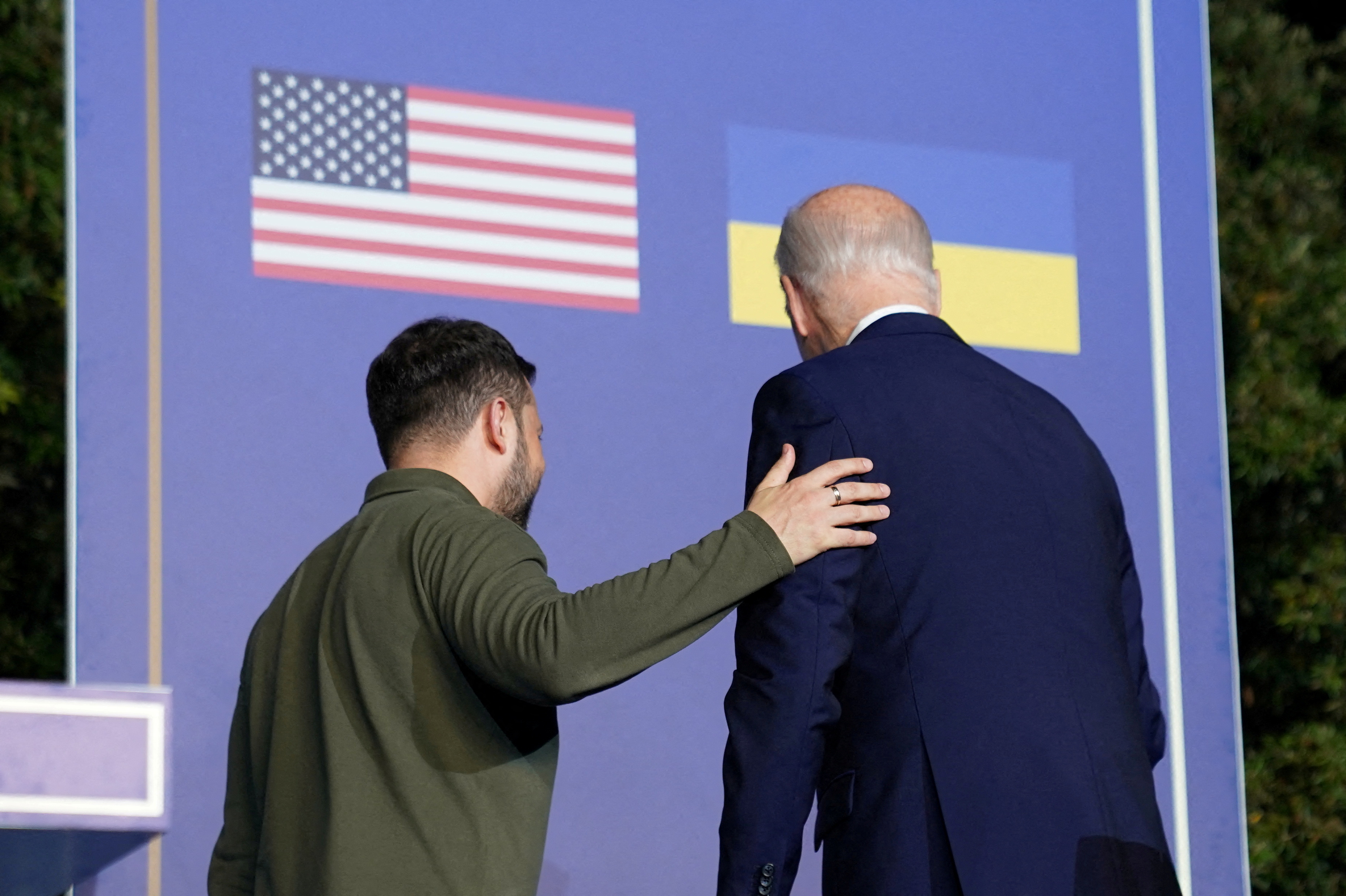 FILE PHOTO: U.S. President Joe Biden and Ukrainian President Volodymyr Zelenskiy walk on the same day the U.S. and Ukraine signed a new security agreement, in Fasano, Italy, June 13, 2024. REUTERS/Kevin Lamarque/File Photo