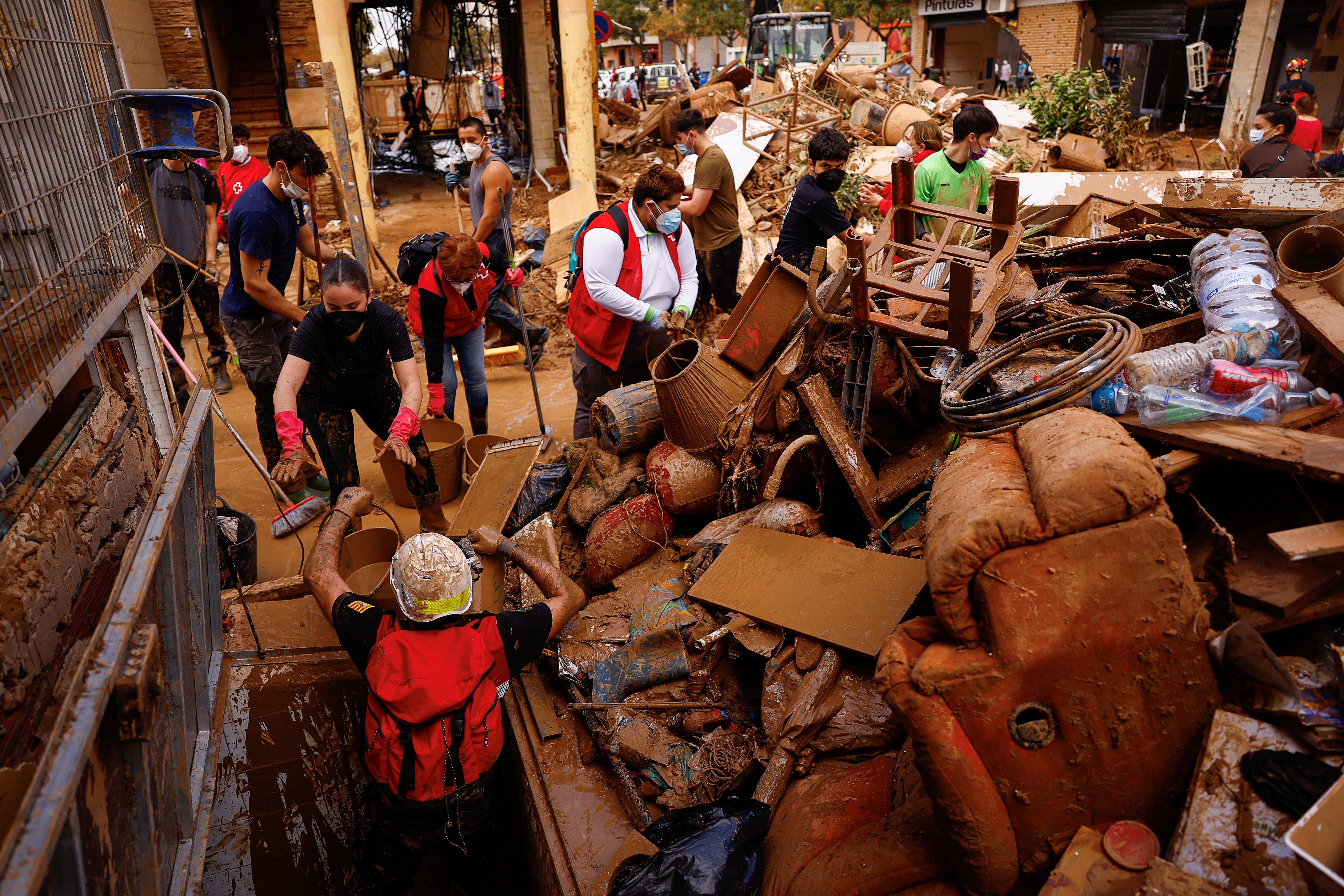 Heavy rains in Barcelona disrupt rail service as troops search for more flood victims in Valencia