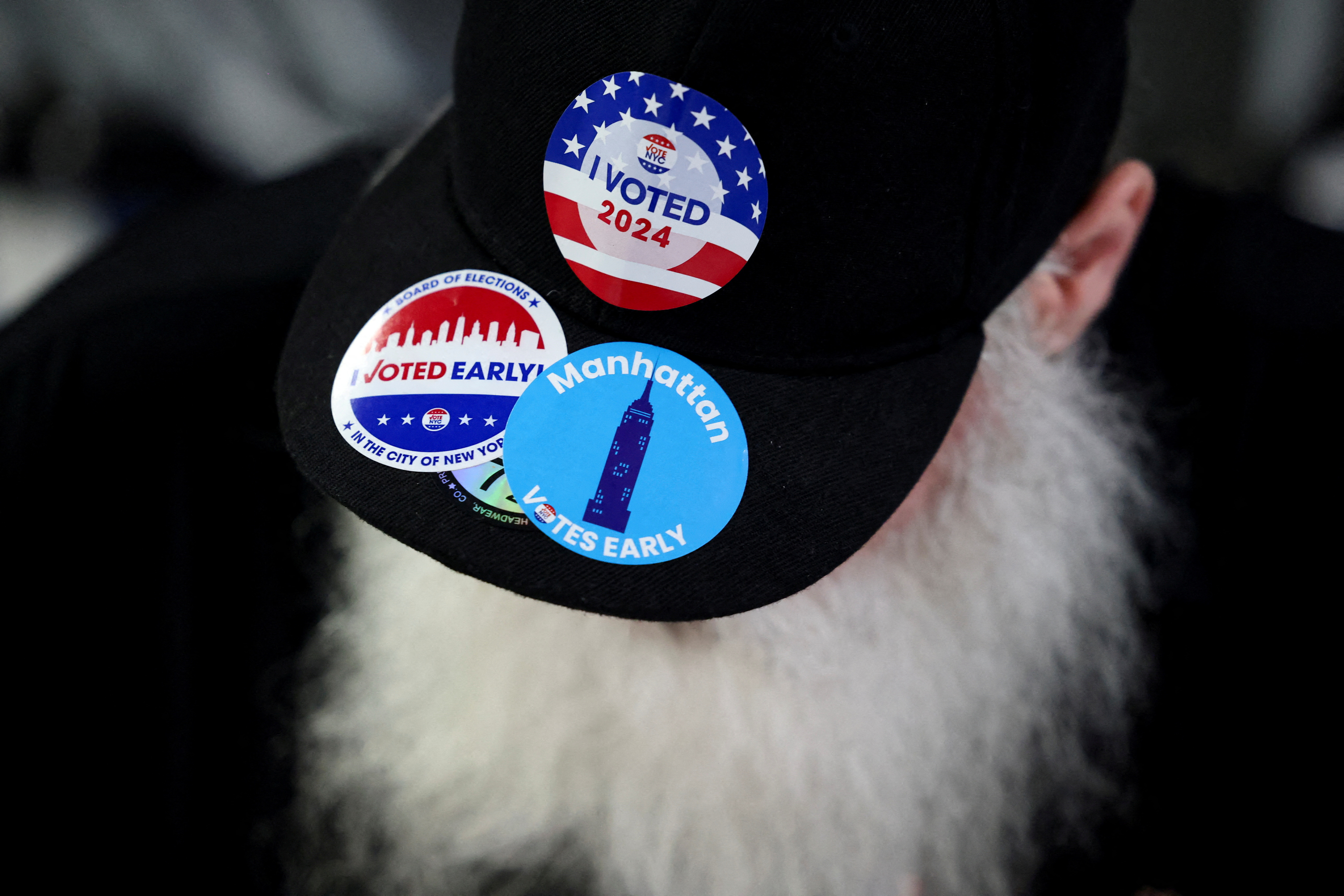 A man wears a hat with stickers, on Election Day for the 2024 U.S. presidential election in Manhattan, New York City, U.S., November 5