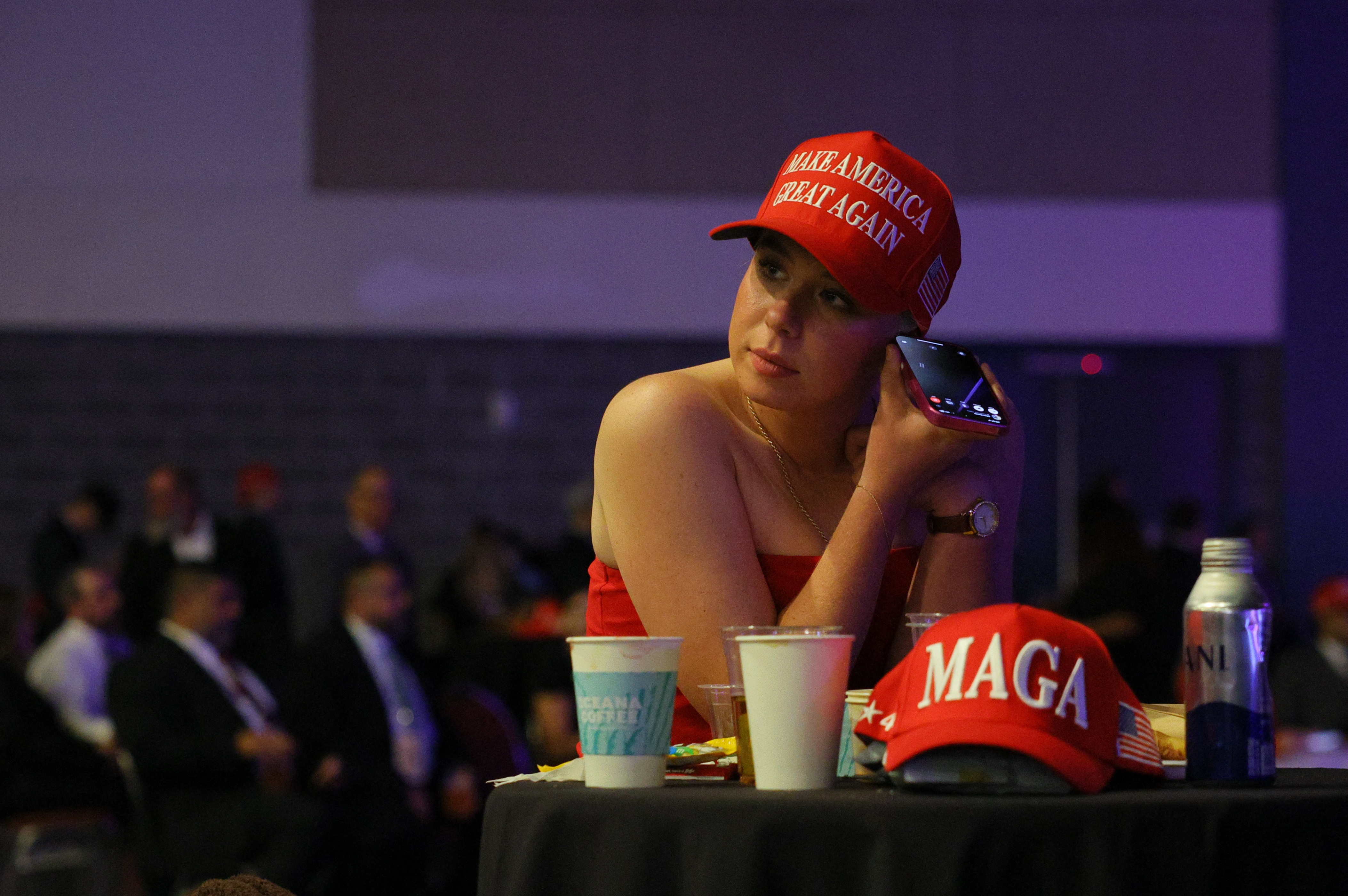 A supporter of Republican presidential nominee and former U.S. President Donald Trump uses a mobile phone at the site of the Election Night rally for Trump, in Palm Beach County Convention Center, in West Palm Beach, Florida, U.S., November 5, 2024.