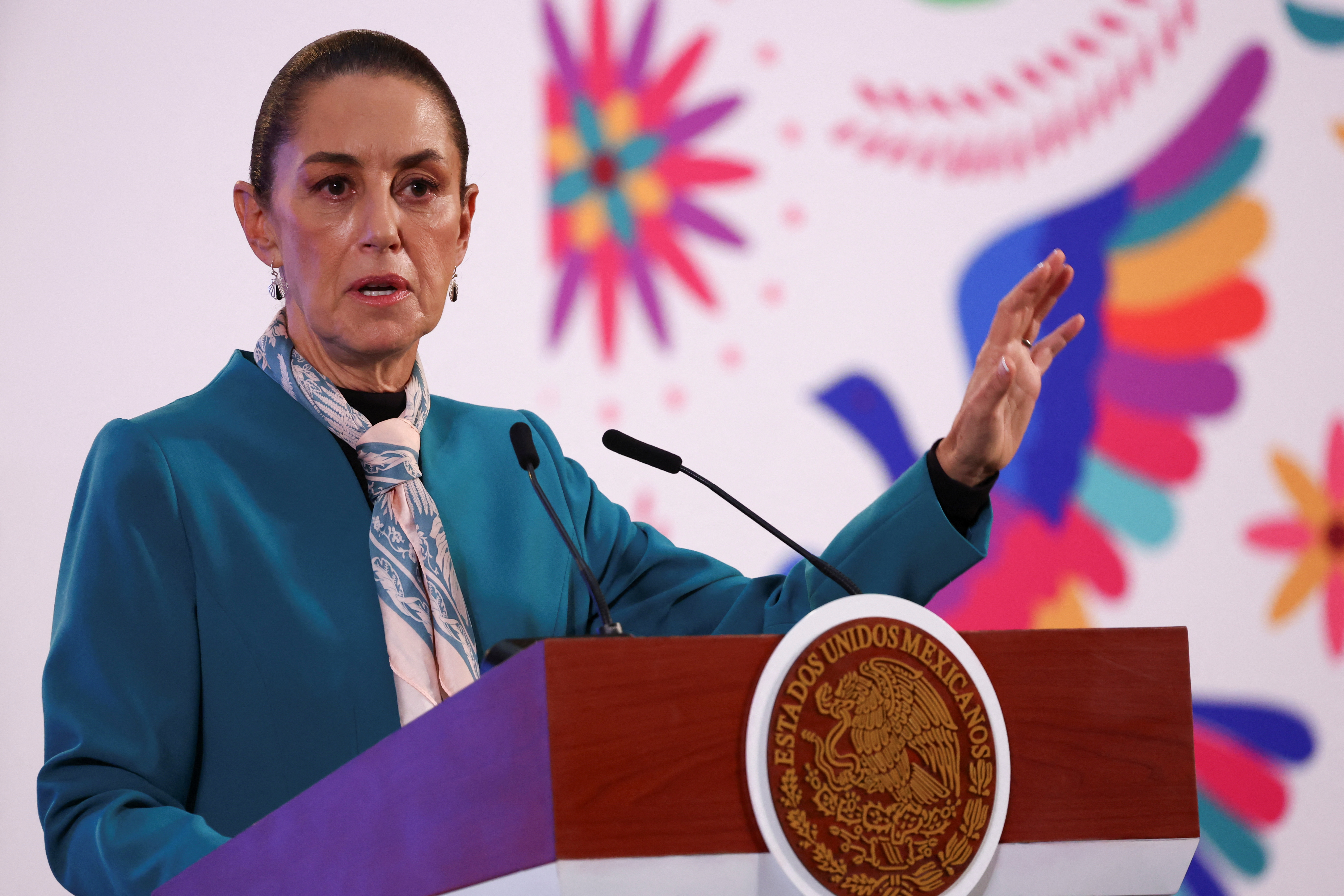 Mexican President Claudia Sheinbaum gestures at a podium