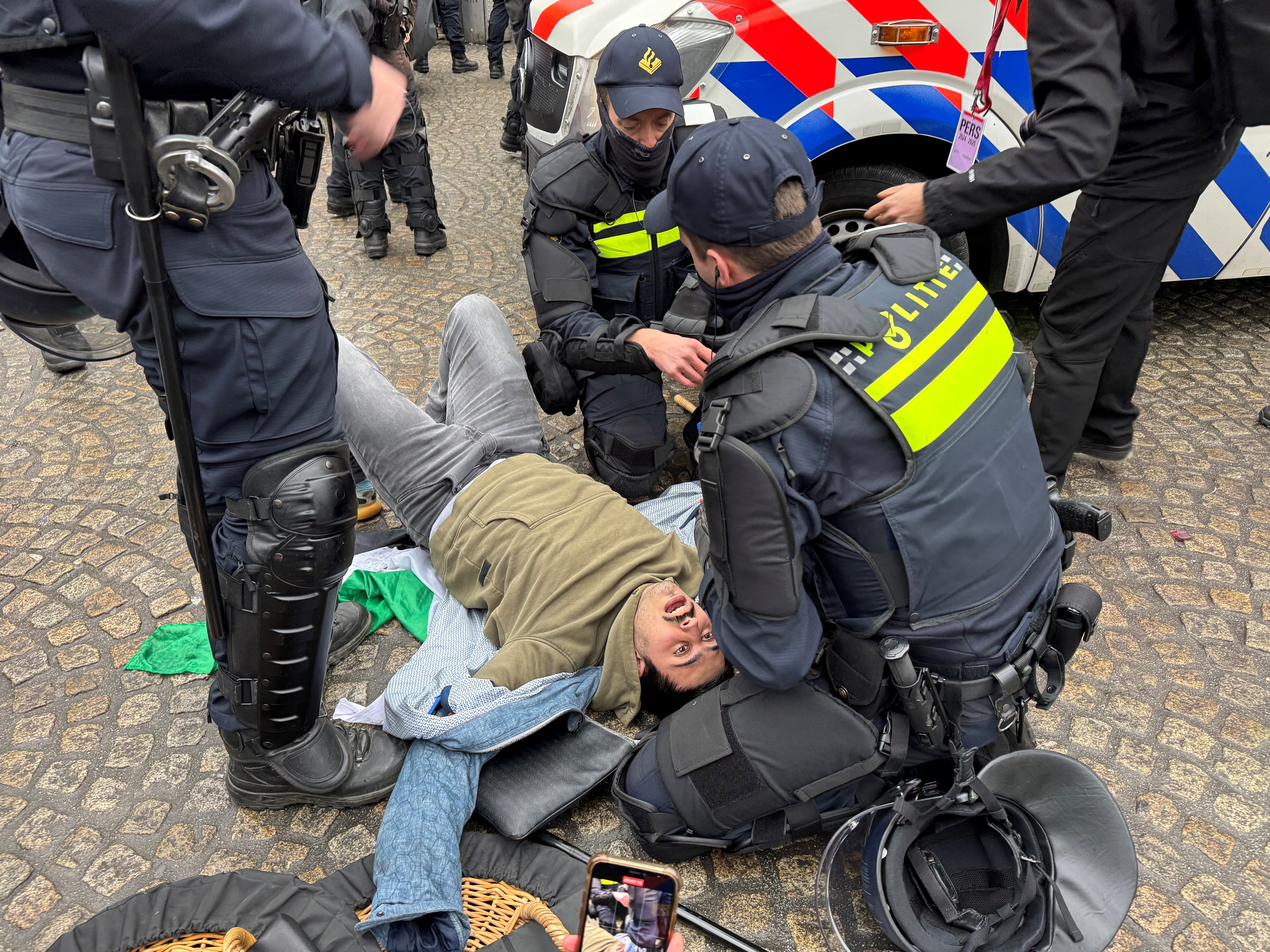 Dutch police help a pro-Palestinian protester during a banned demonstration in Amsterdam, Netherlands November 10, 2024. REUTERS/Anthony Deutsch TPX IMAGES OF THE DAY