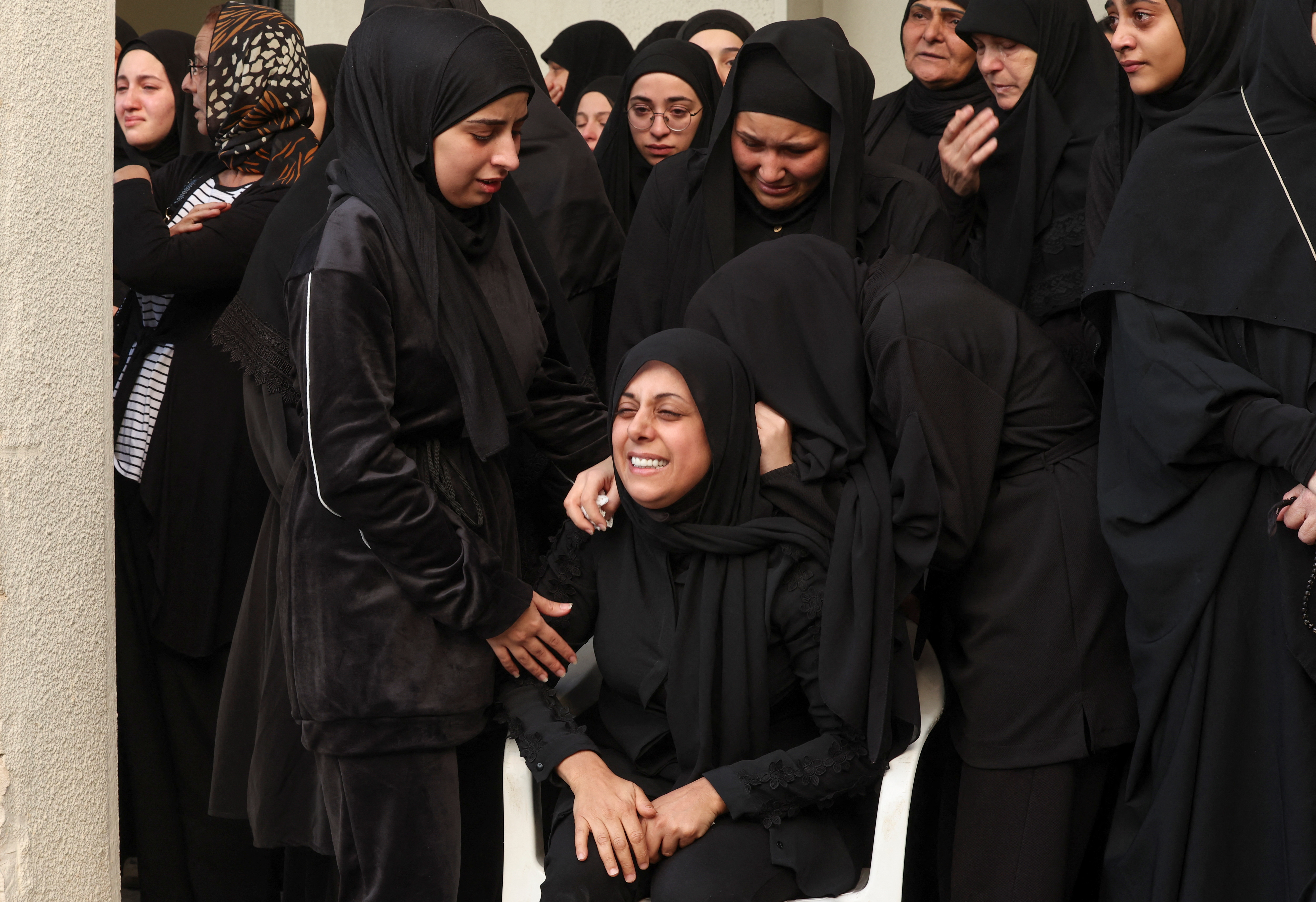 A mourner reacts during the funeral of her relative who was killed in Israeli strikes,