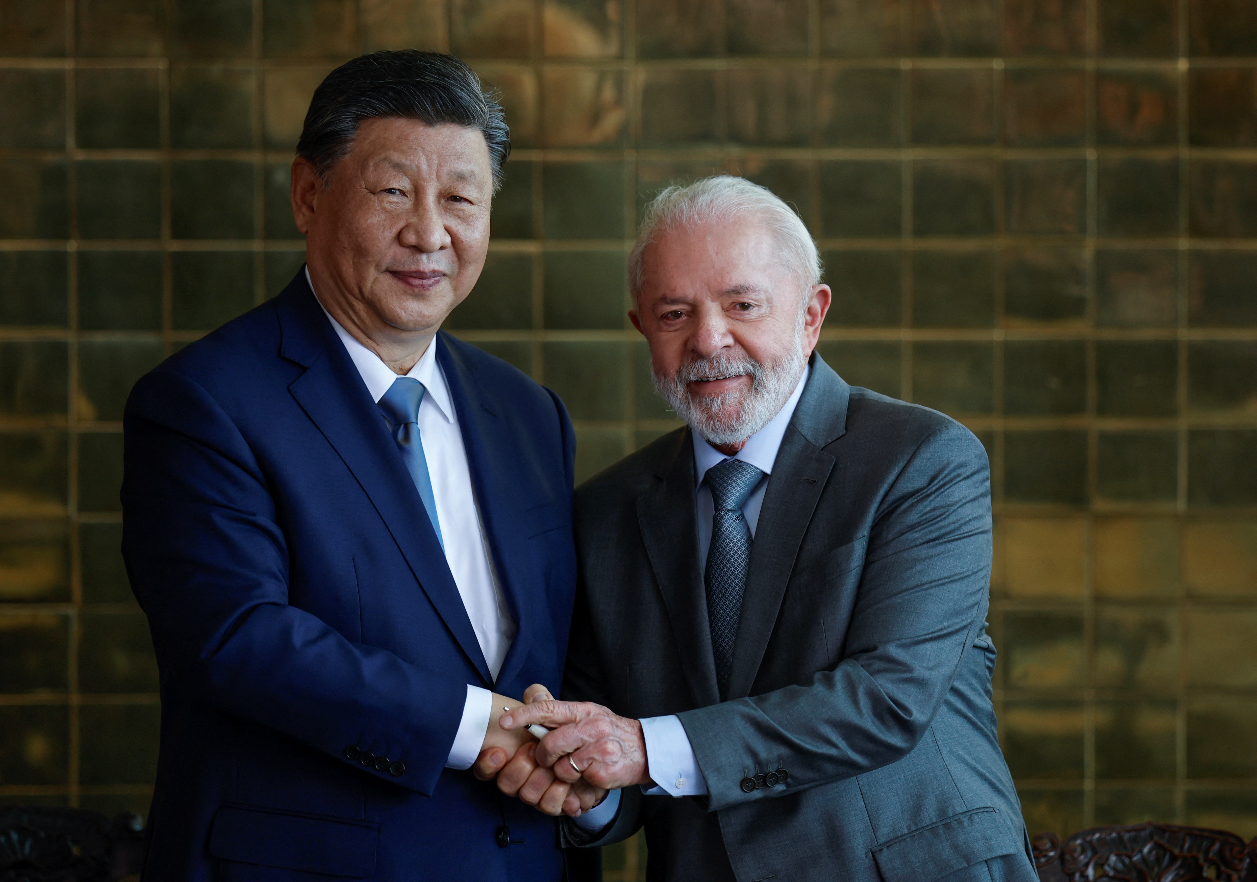 China's Xi Jinping shakes hands with Brazil's Luiz Inacio Lula da Silva