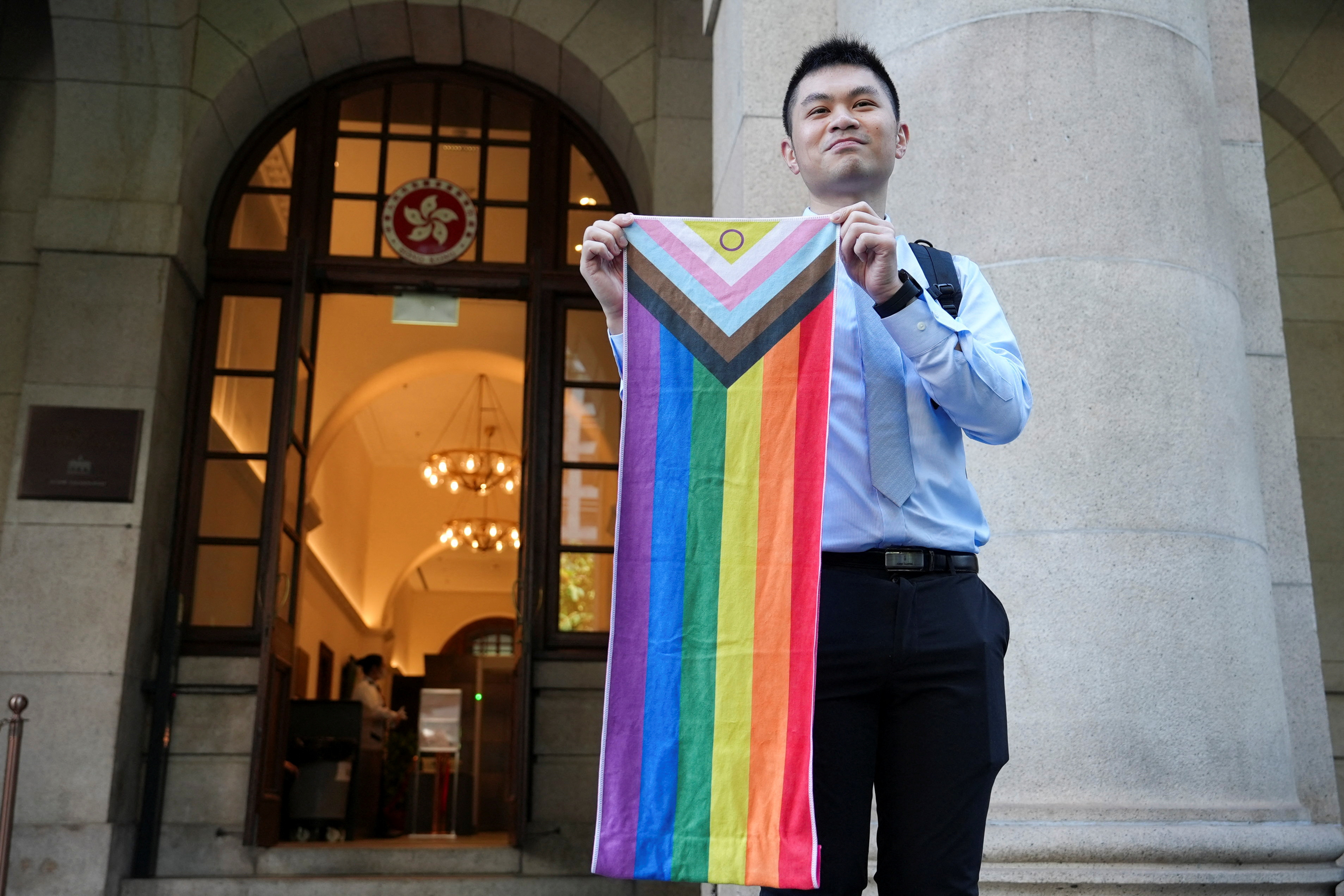 Nick Infinger holds intersex-inclusive pride progress flag after Hong Kong's top court rules in favour of equal housing and inheritance rights for same-sex couples in Hong Kong, China November 26, 2024. REUTERS/Joyce Zhou