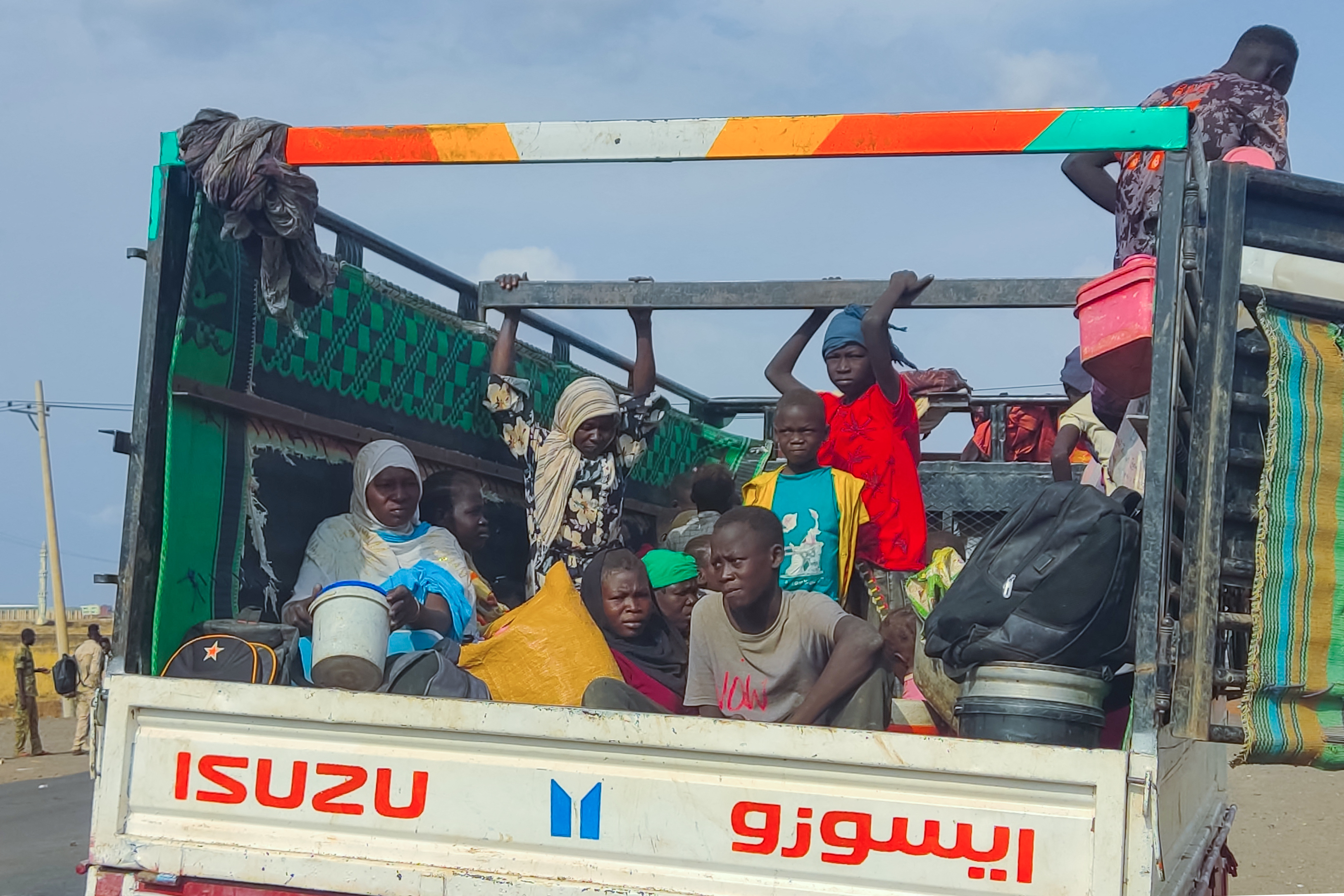 Peolpe displaced from Sudan's Jazira state arrive in packed vehicles to the entrance of the eastern city of Gedaref on June 10, 2024, amid the ongoing conflict between the Sudanese army and the paramilitary Rapid Support Forces (RSF). (Photo by AFP)