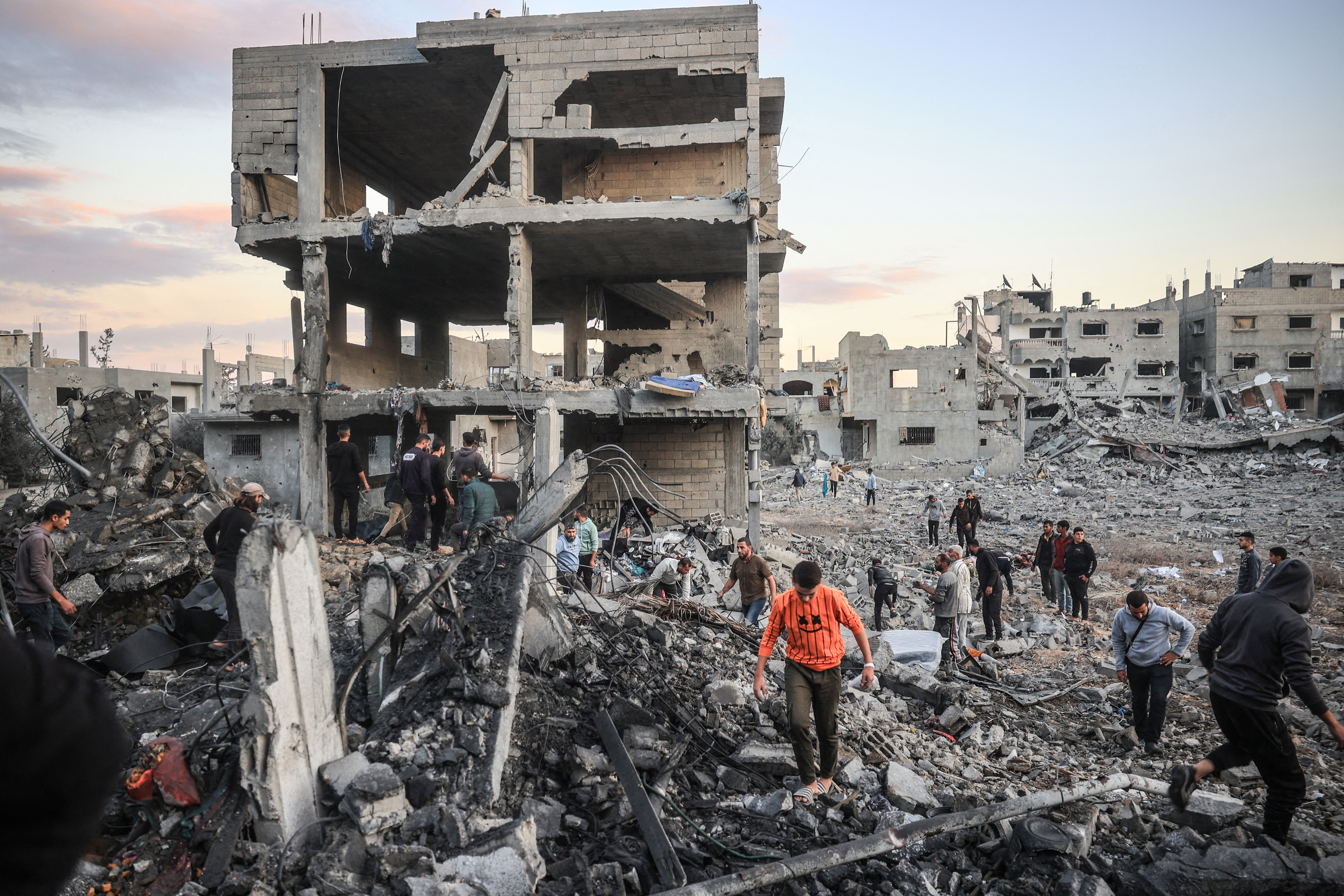Palestinians inspect the damage at the site of an Israeli airstrike on the Bureij refugee camp
