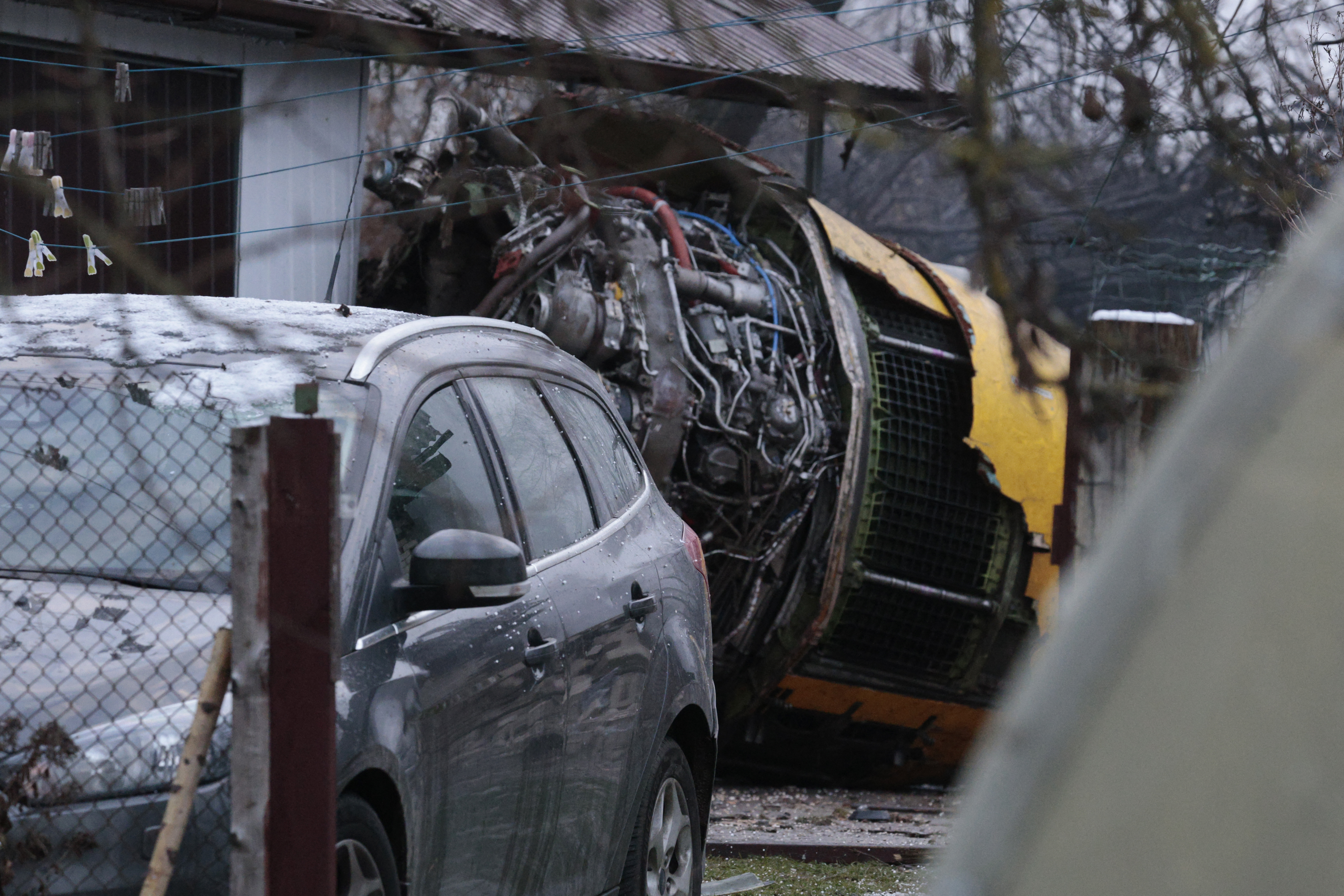 This photograph taken on November 25, 2024 shows the wreckage of a cargo plane in the courtyard of a house following its crash near the Vilnius International Airport in Vilnius. - A cargo plane flying from Germany to Lithuania crashed early on November 25, 2024 near the airport of the capital Vilnius killing one person, firefighters said. (Photo by Petras MALUKAS / AFP)