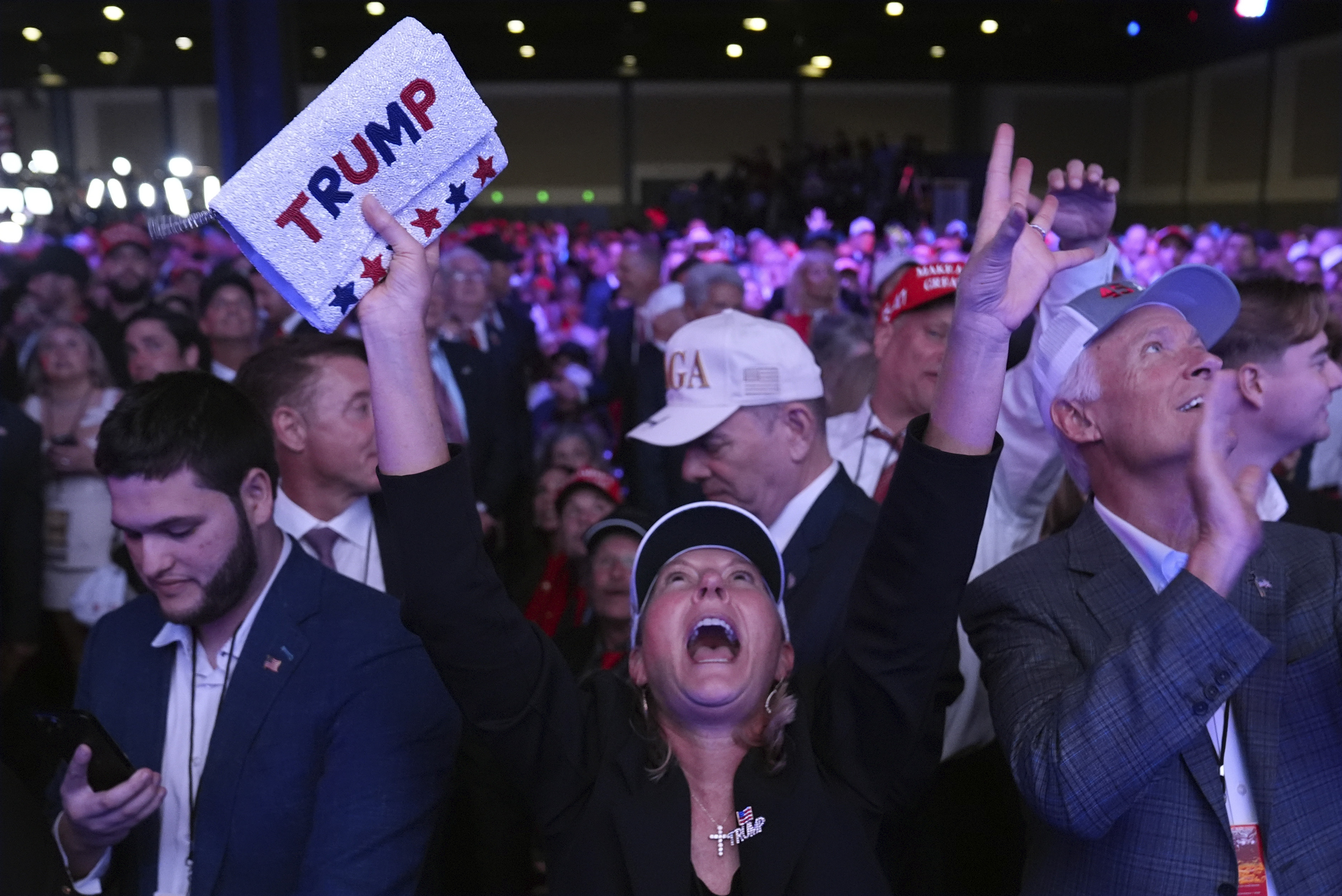 Supporters watch returns at a campaign election night watch party for Republican presidential nominee former President Donald Trump at the Palm Beach Convention Center, Wednesday, Nov. 6