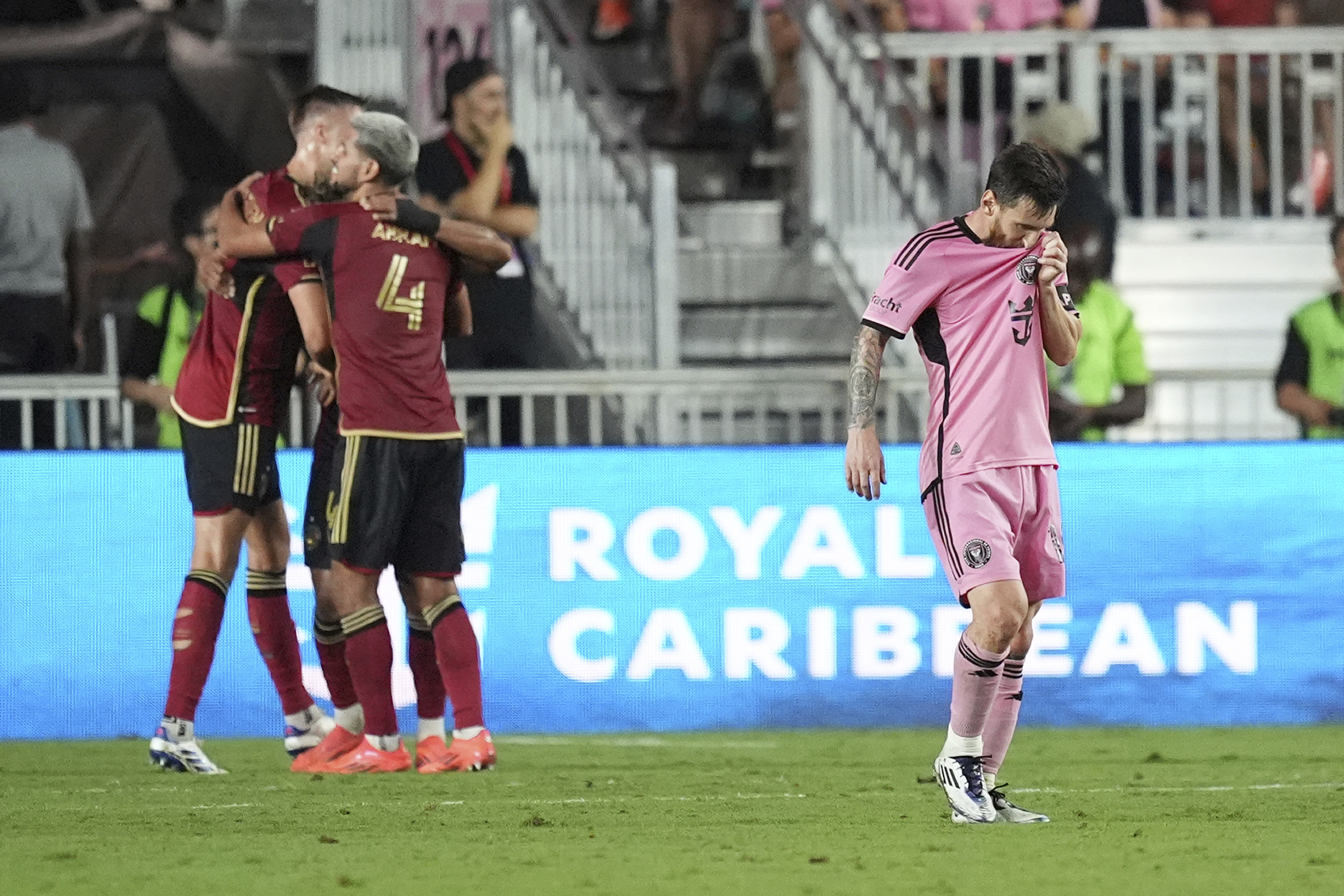 Atlanta United players celebrate as Inter Miami forward Lionel Messi (10) leaves the pitch at the end of their MLS playoff opening round soccer match, Saturday, Nov. 9, 2024, in Fort Lauderdale, Fla. (AP Photo/Rebecca Blackwell)