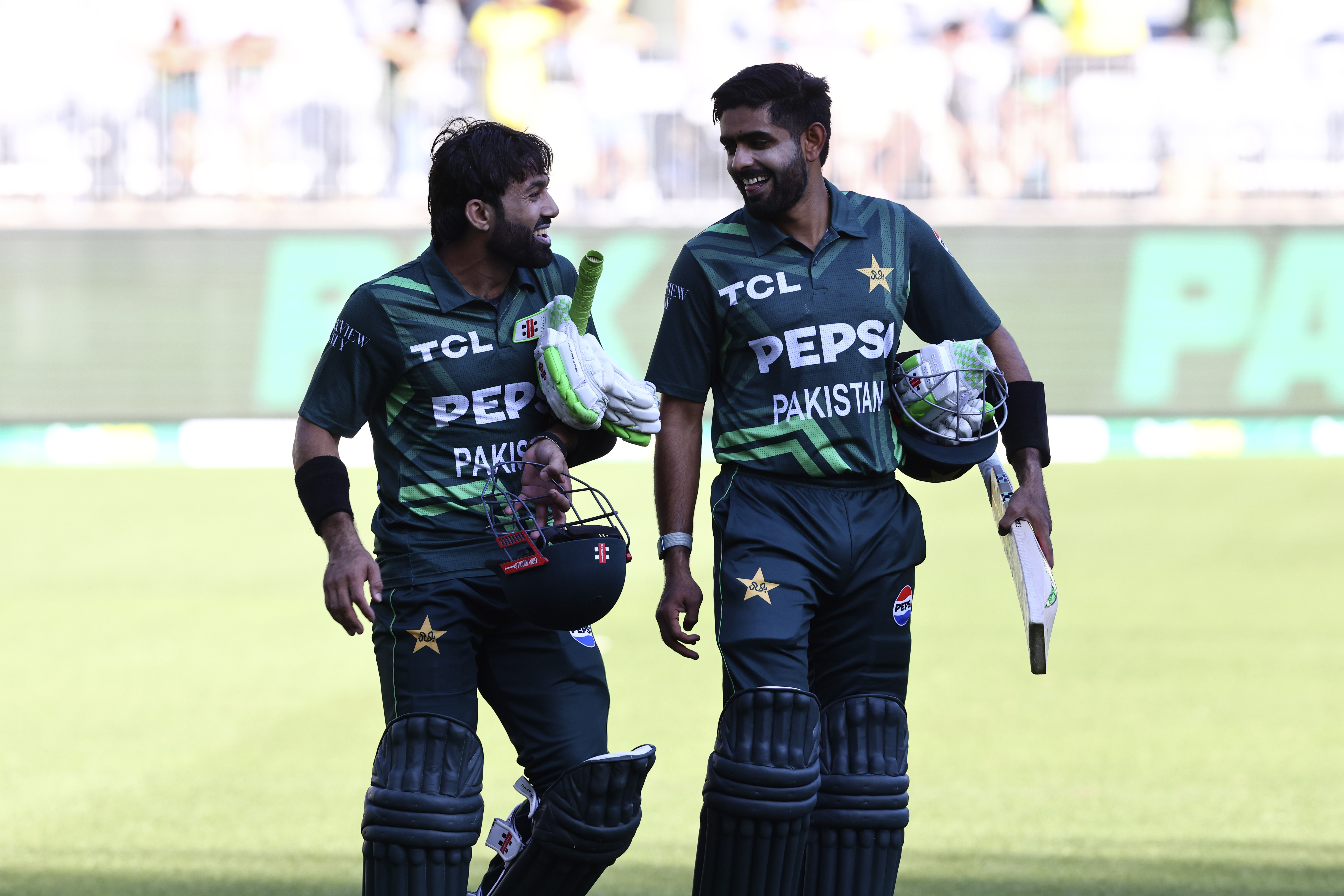 Pakistan's not out batters Mohammad Rizwan, left, and Babar Azam smile after their win in their one day international cricket match against Australia in Perth, Australia, Sunday, Nov. 10, 2024. (AP Photo/Trevor Collens)