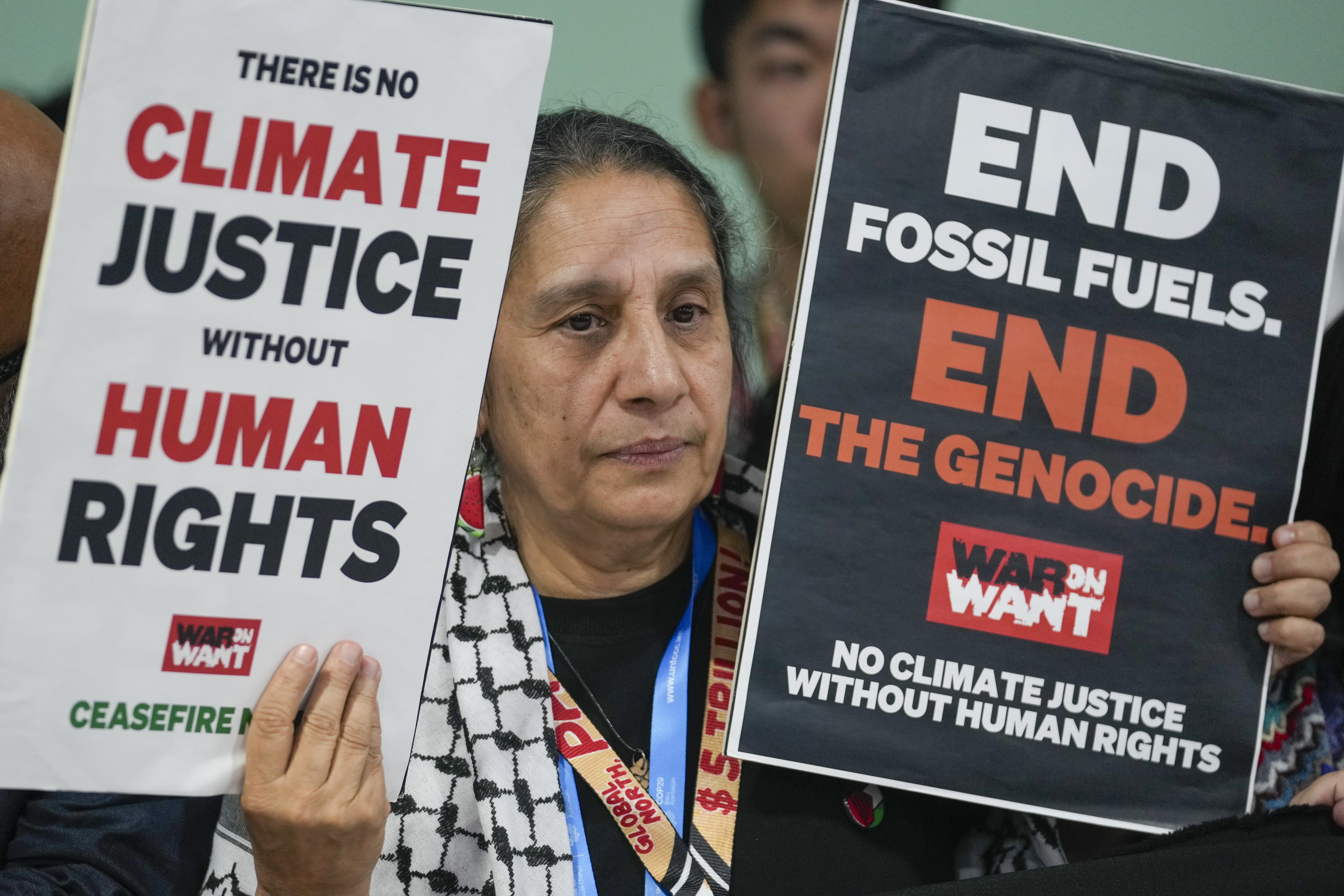 An activist demonstrates for climate justice and a ceasefire for Gaza
