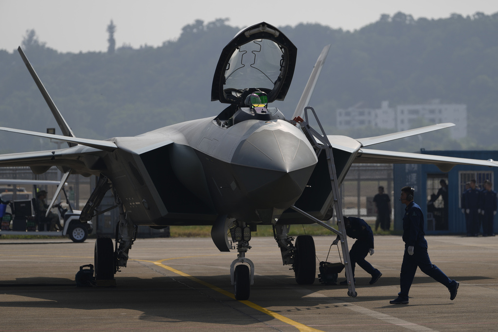 Ground crew attend to a Chinese J-20 stealth fighter jet after it's performance at the 15th China International Aviation and Aerospace Exhibition, also known as Airshow China 2024 at Zhuhai in southern China's Guangdong province on Tuesday, Nov. 12, 2024.(AP Photo/Ng Han Guan)