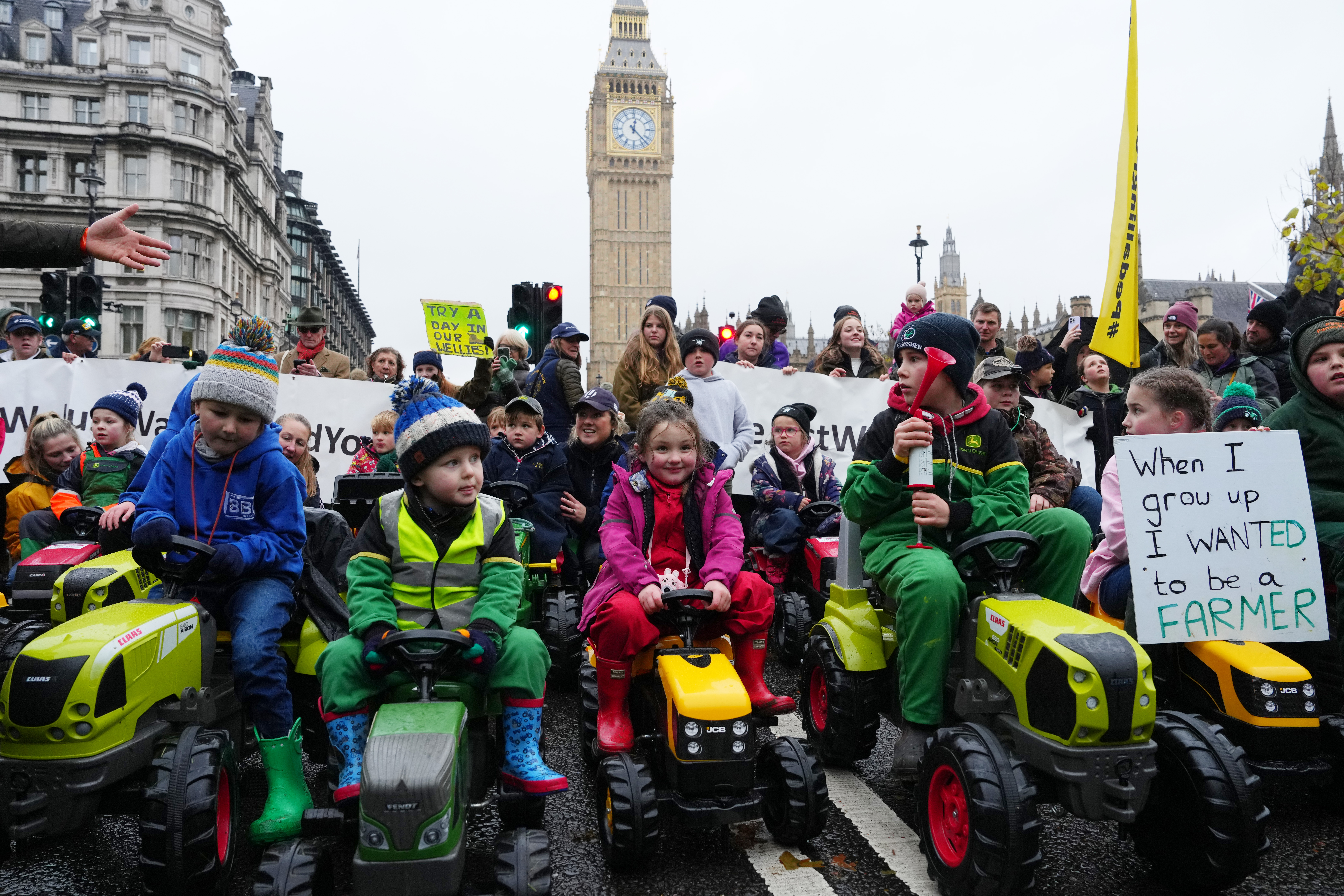 Children ride toy tractors in Parliament Square