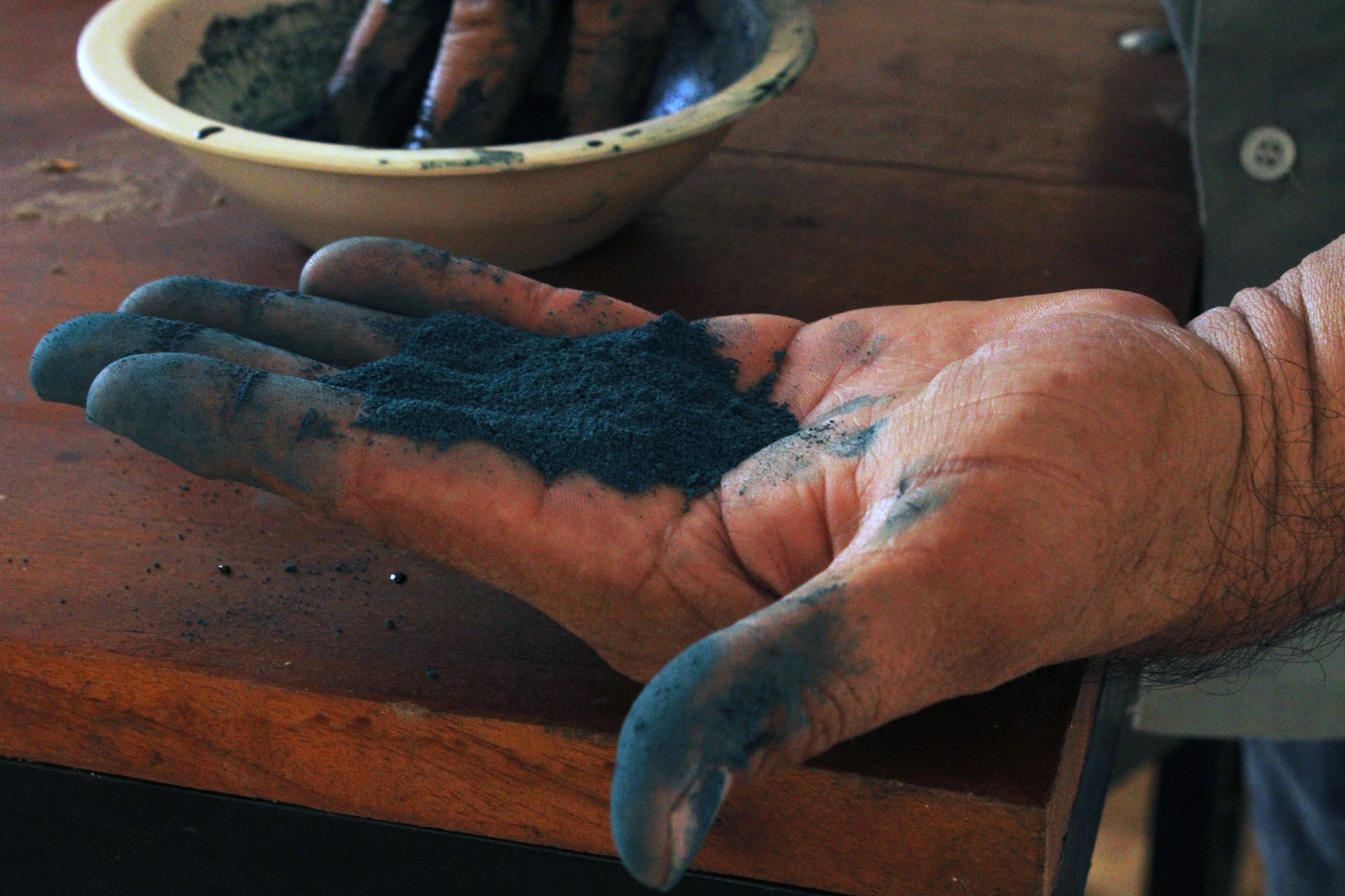 Luis May Ku, 49, holds the finished powdered product of Maya Blue pigment in his home in Dzan, Yucatán, Mexico, on 9 September, 2024_-1731948304