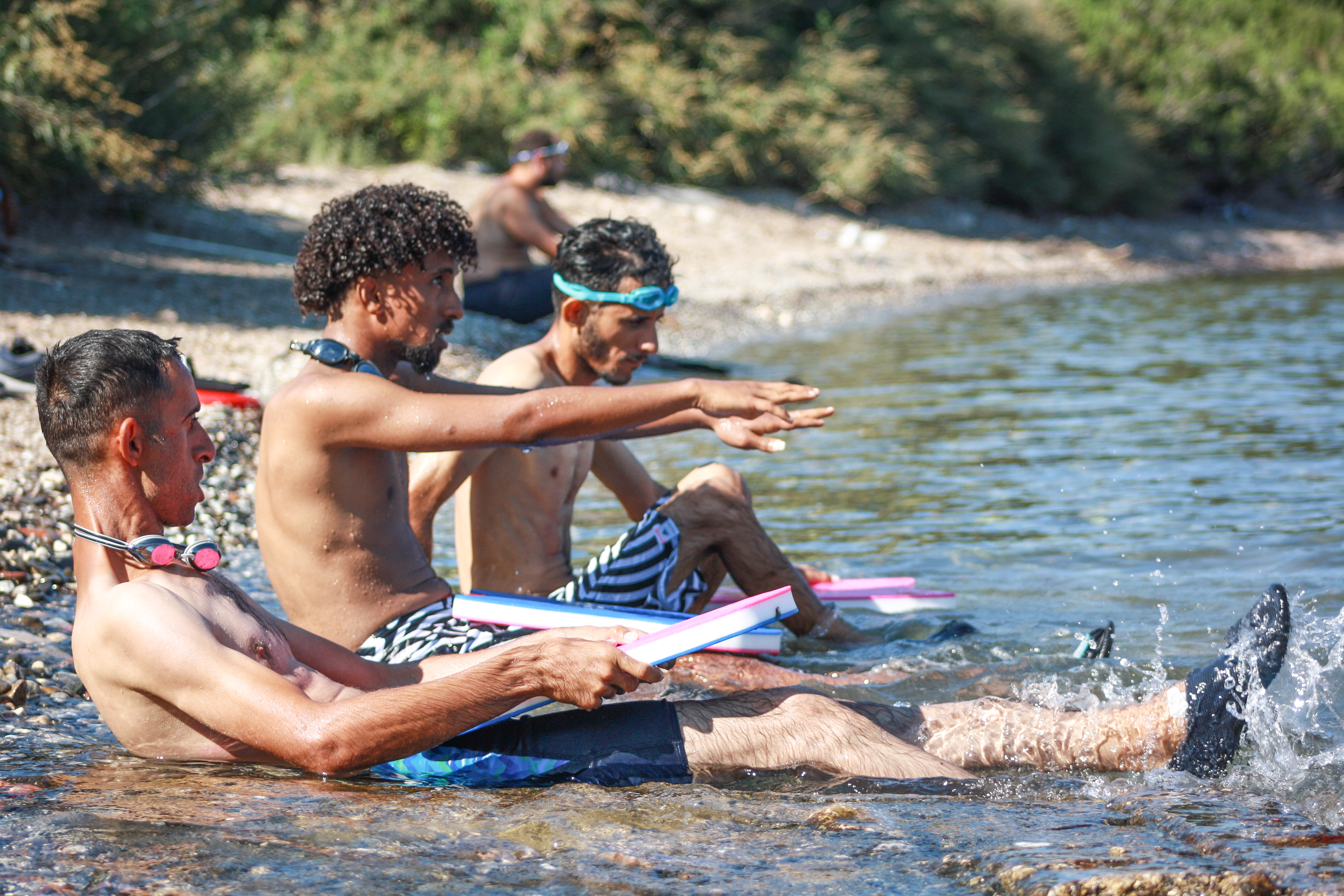 Students with no previous swimming experience follow the instructions for the correct body position in the water. [Dario Antonelli/Al Jazeera]