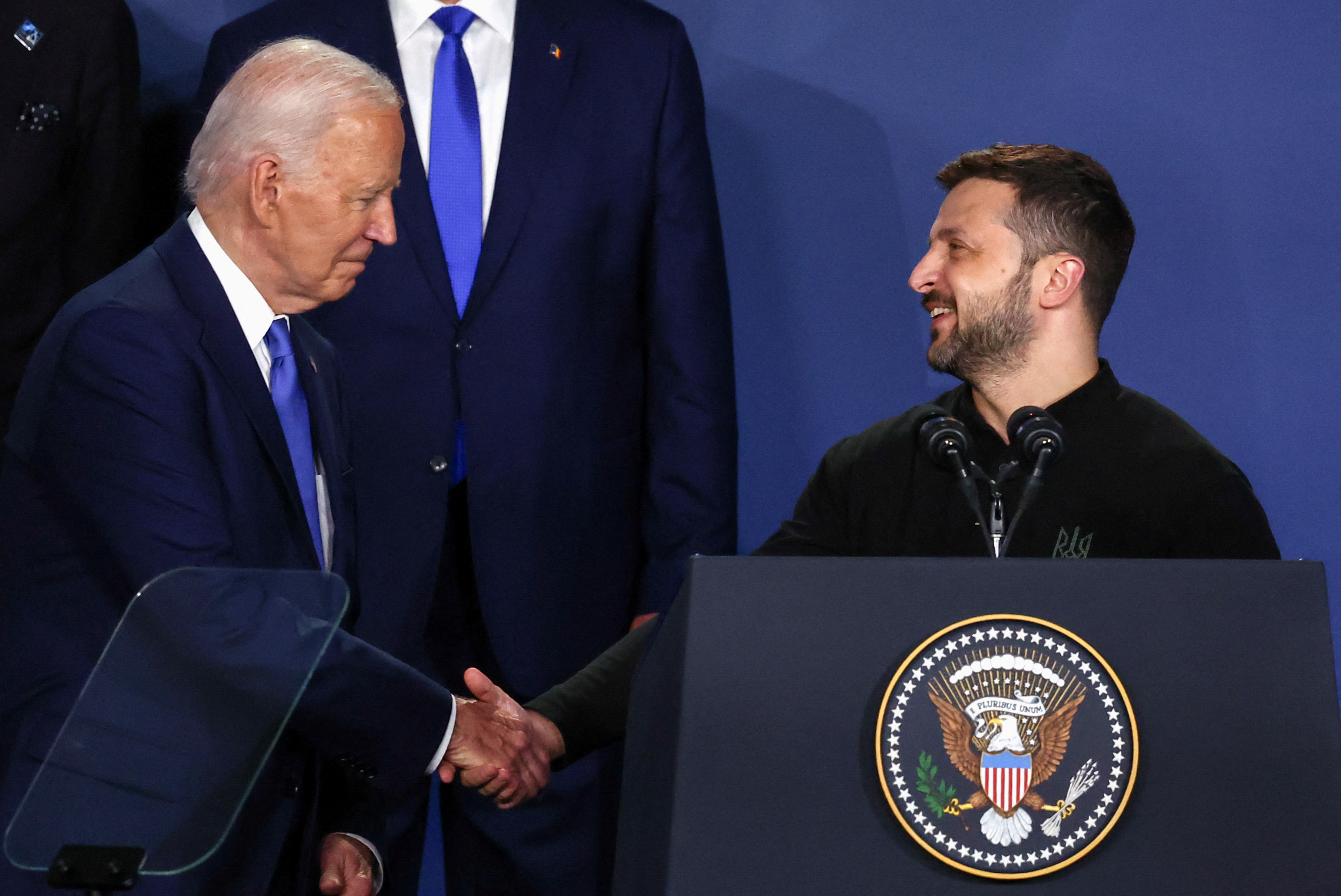 Ukraine's President Volodymyr Zelenskiy and U.S. President Joe Biden shake hands at a Ukraine Compact meeting, on the sidelines of the NATO's 75th anniversary summit in Washington, U.S. July 11, 2024.
