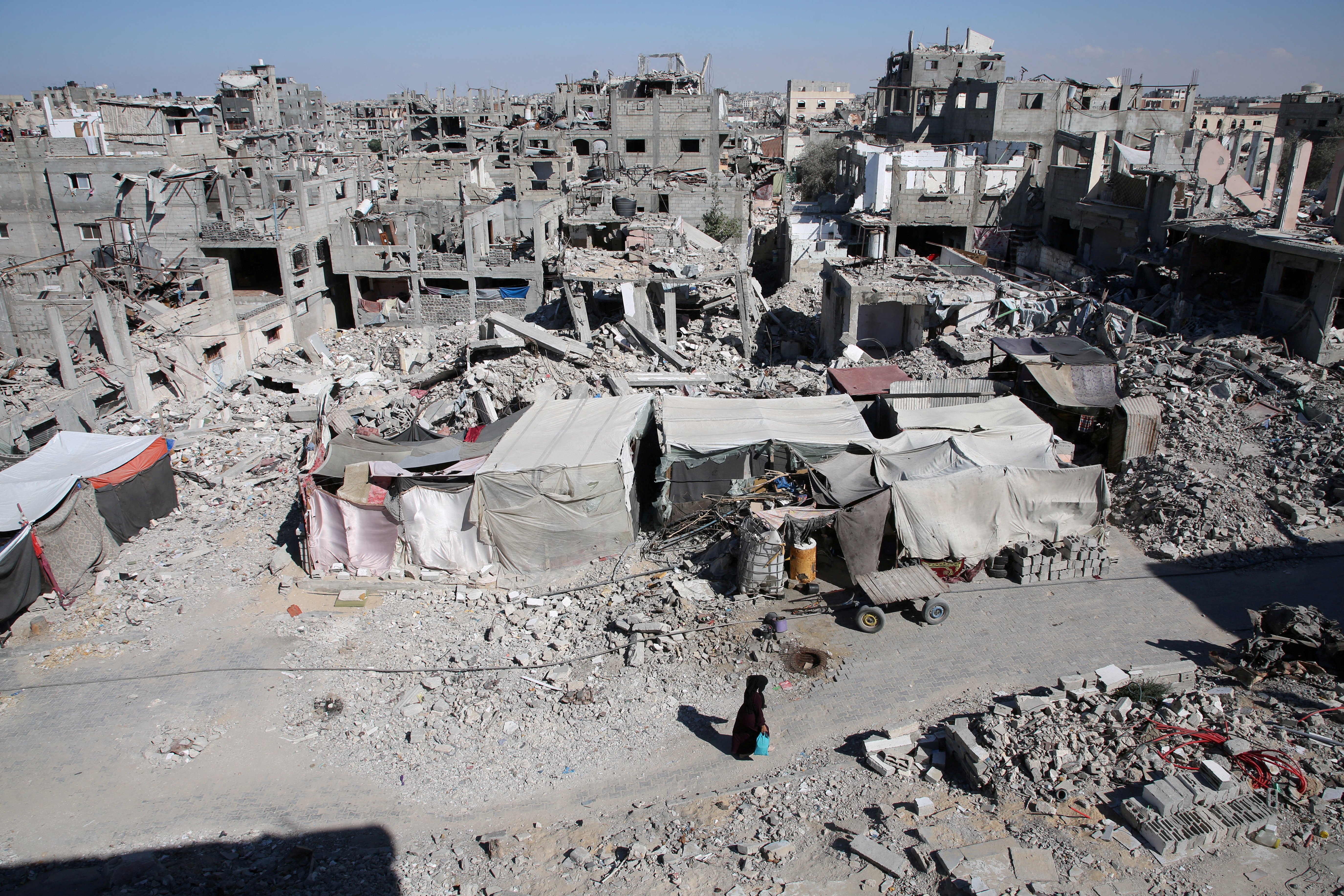 A Palestinian walks past the rubble of houses destroyed by Israeli strikes, amid Israel-Hamas conflict, in Khan Younis in the southern Gaza Strip, September 4