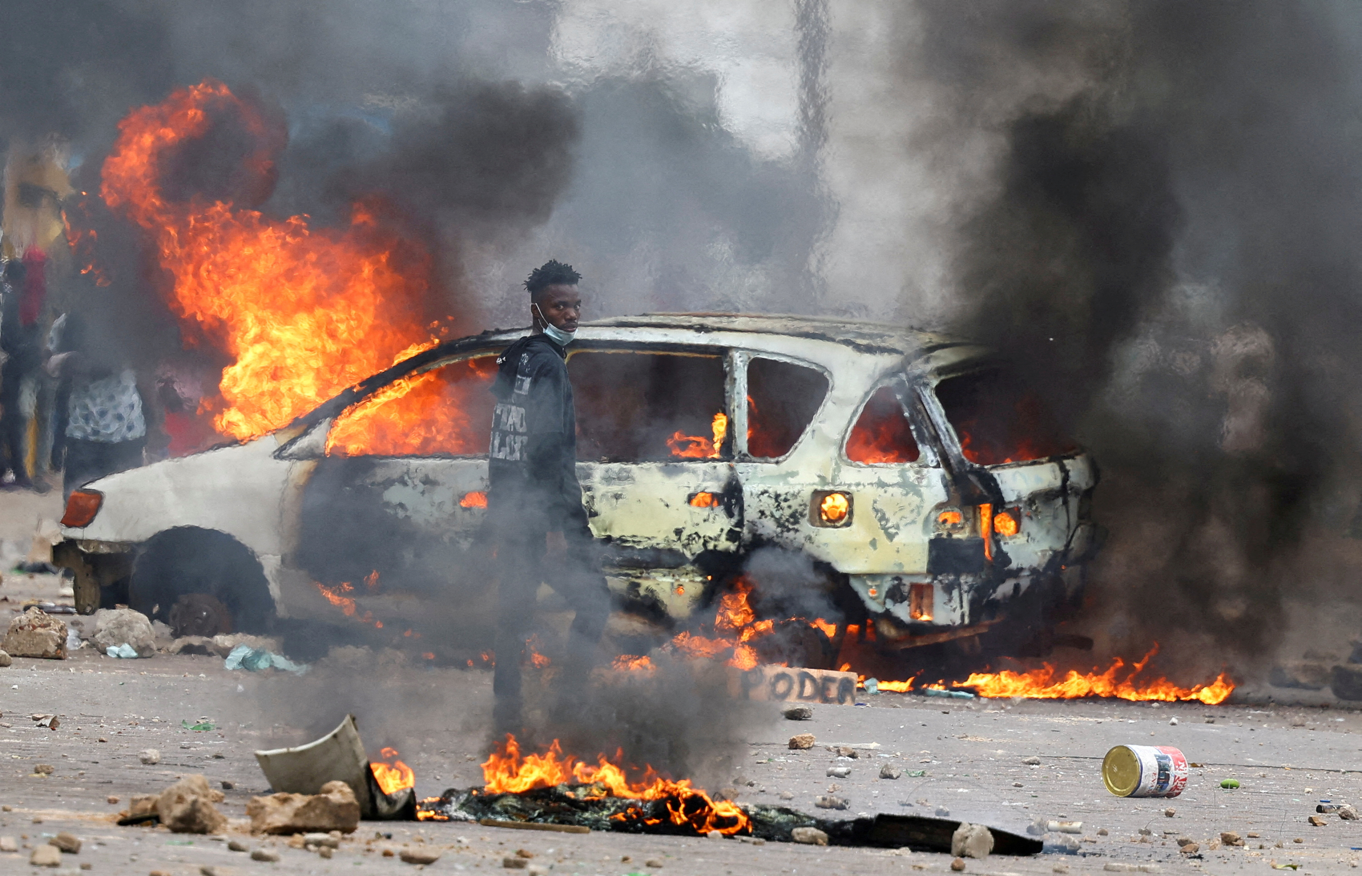 A protester looks on near a burning barricade during a "national shutdown" against the election outcome, in Maputo, Mozambique, November 7, 2024. [Siphiwe Sibeko/Reuters]