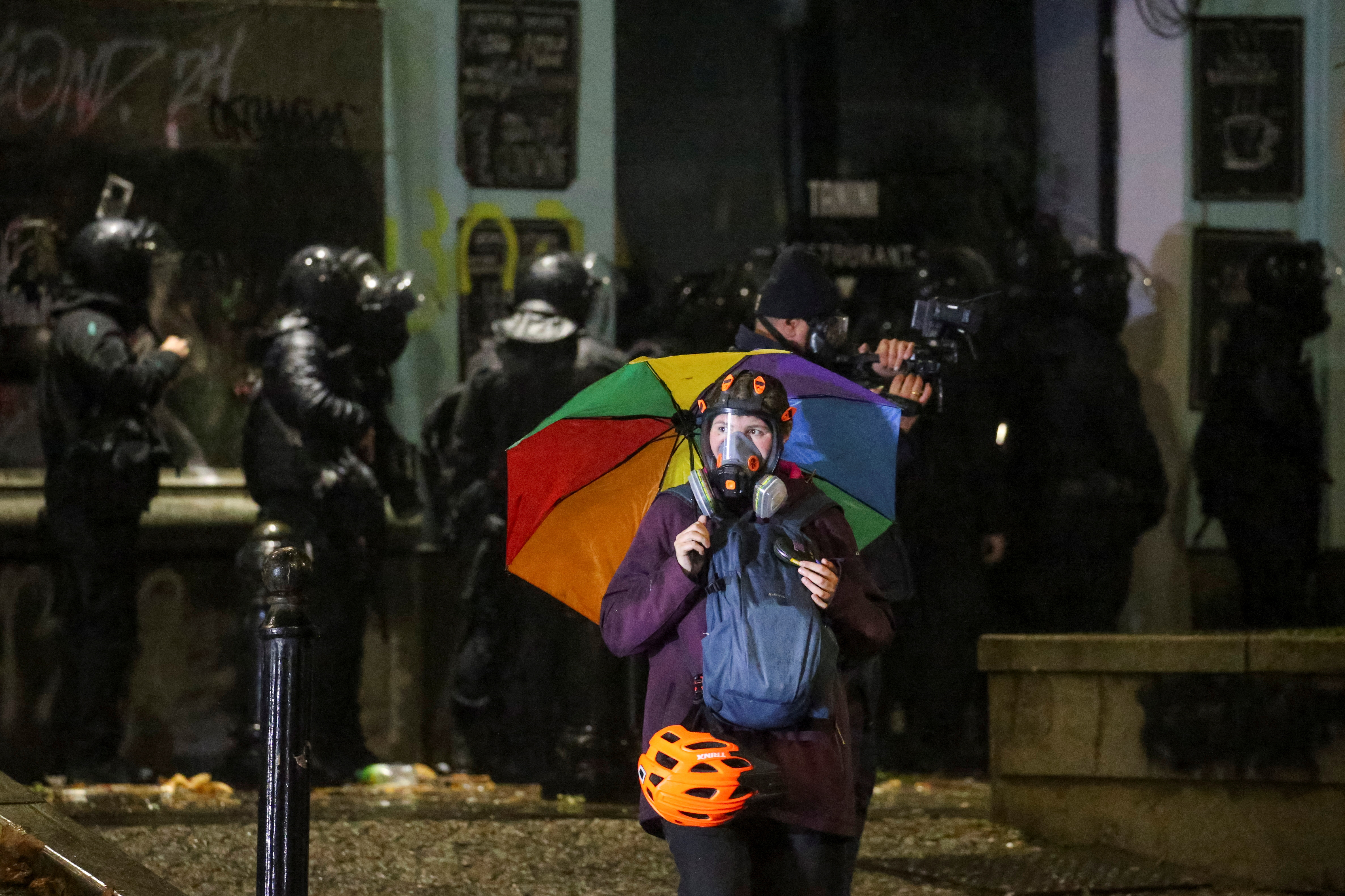 A person wears a gas mask as police officers operate during a protest against the new government's decision to suspend the European Union accession talks and refuse budgetary grants until 2028, in Tbilisi, Georgia December 2, 2024. REUTERS/Irakli Gedenidze