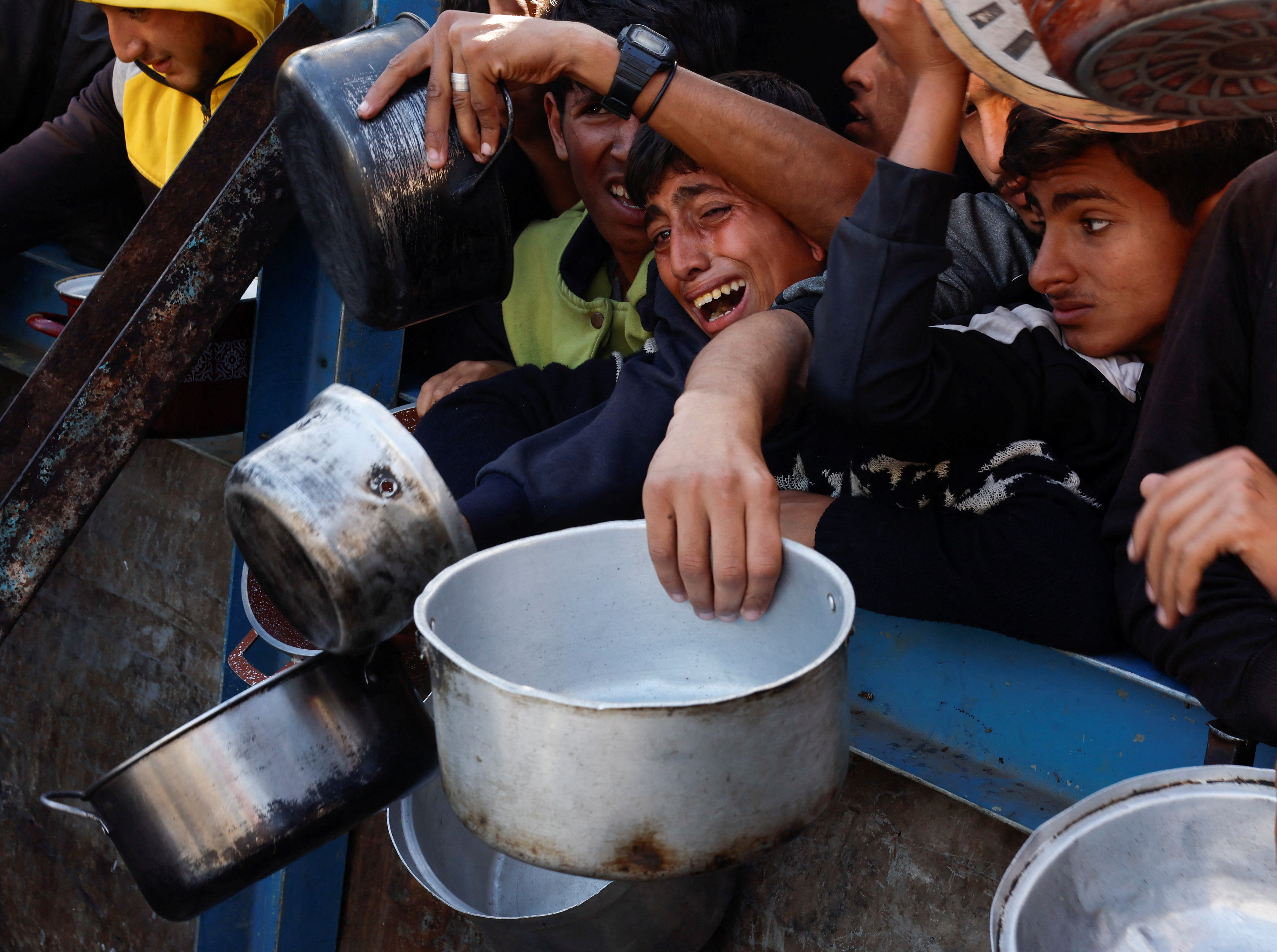 Palestinian children gather to receive food in Gaza amid Israel's war