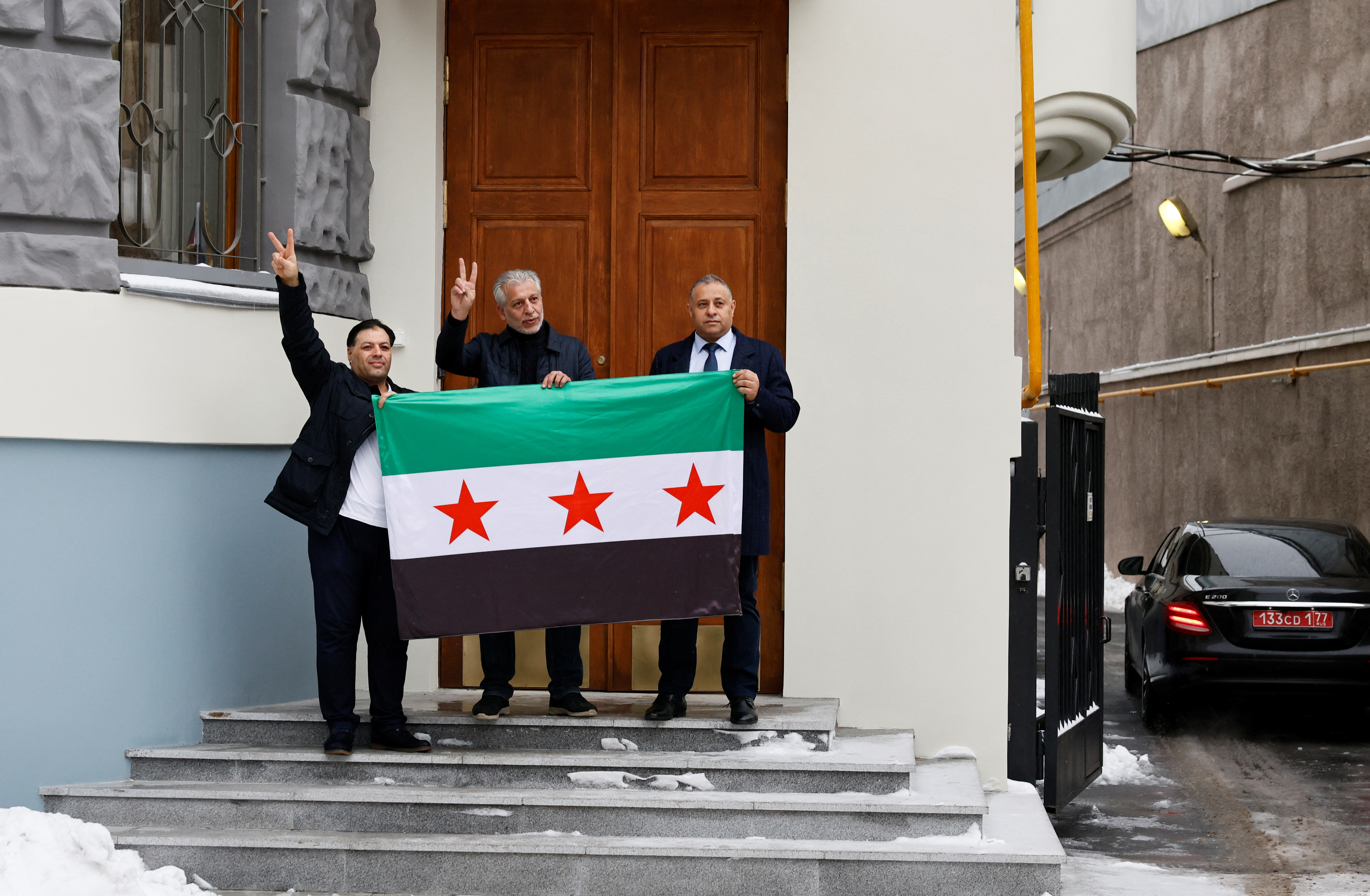 Images with the Syrian opposition flag raised at the embassy in Moscow
