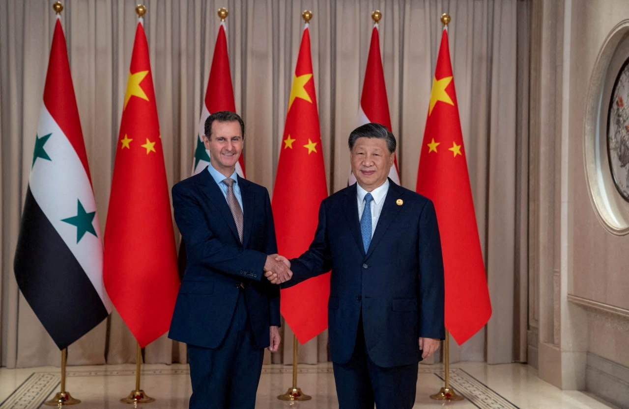 Chinese President Xi Jinping shakes hands with Syria's President Bashar al-Assad in eastern Hangzhou city, in this handout picture released by Sana on September 22, 2023, Syria.