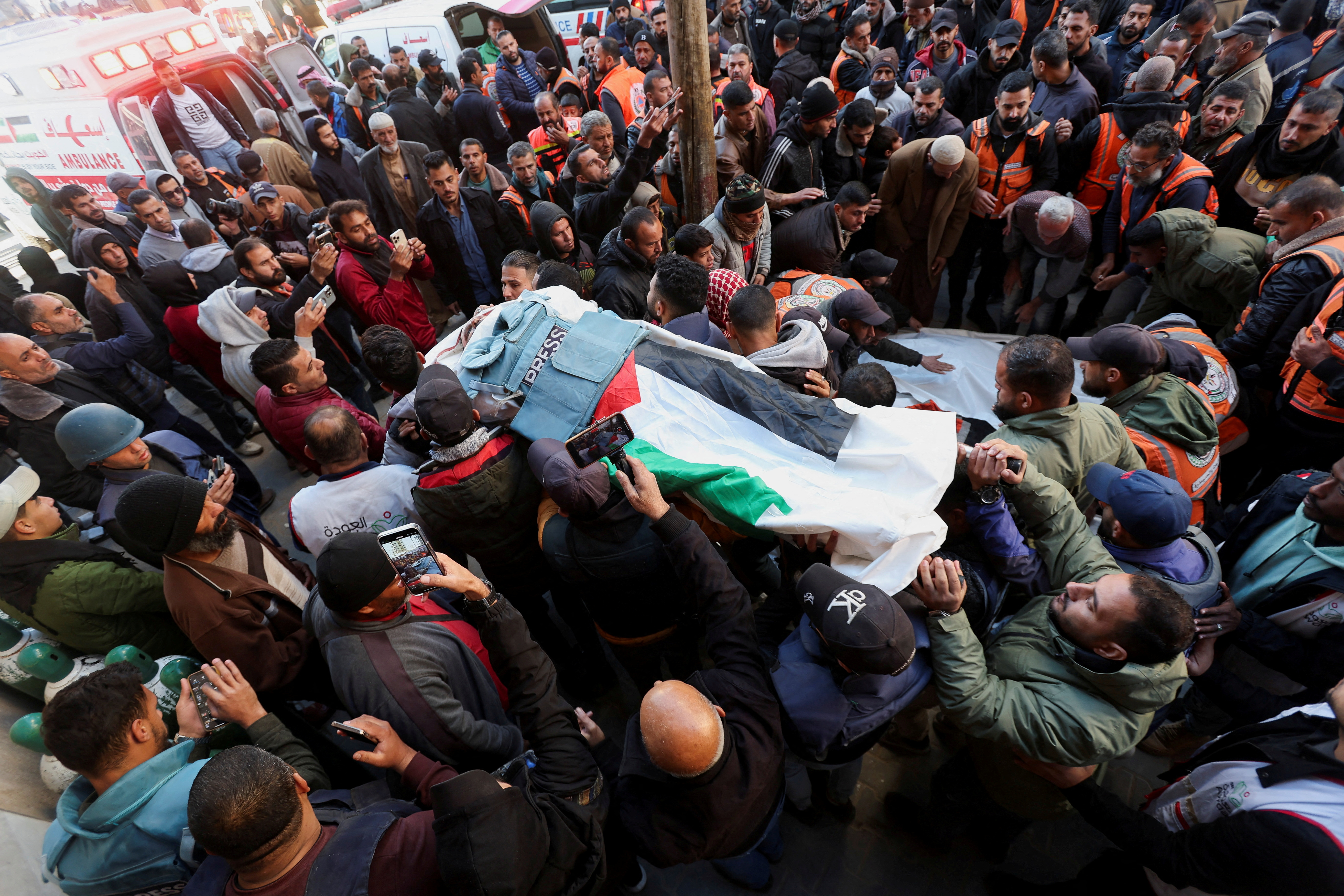Mourners attend the funeral of Palestinian journalist Ahmed Al-Louh