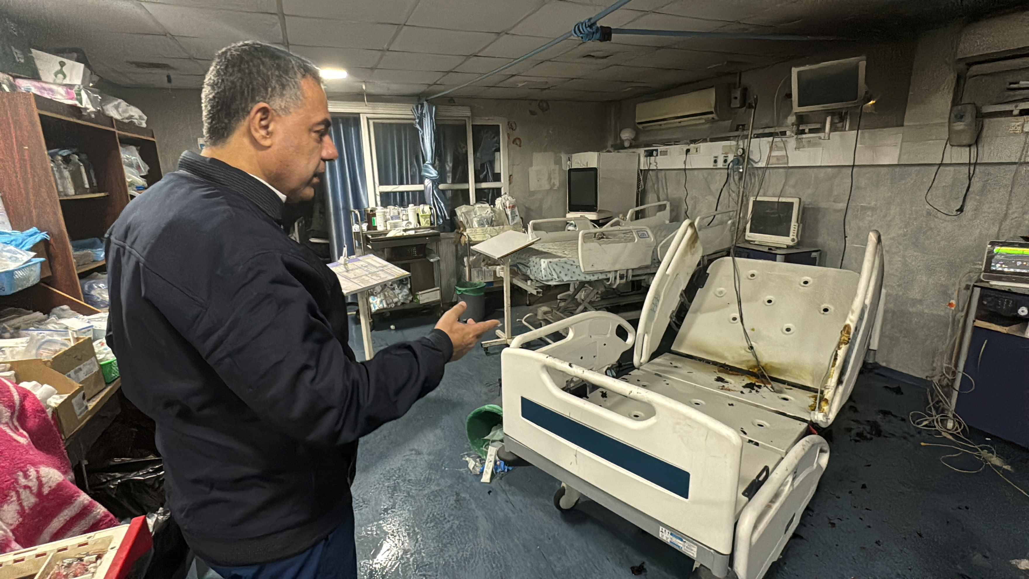 Hussam Abu Safiya, director of Kamal Adwan Hospital, shows the damage inside the hospital