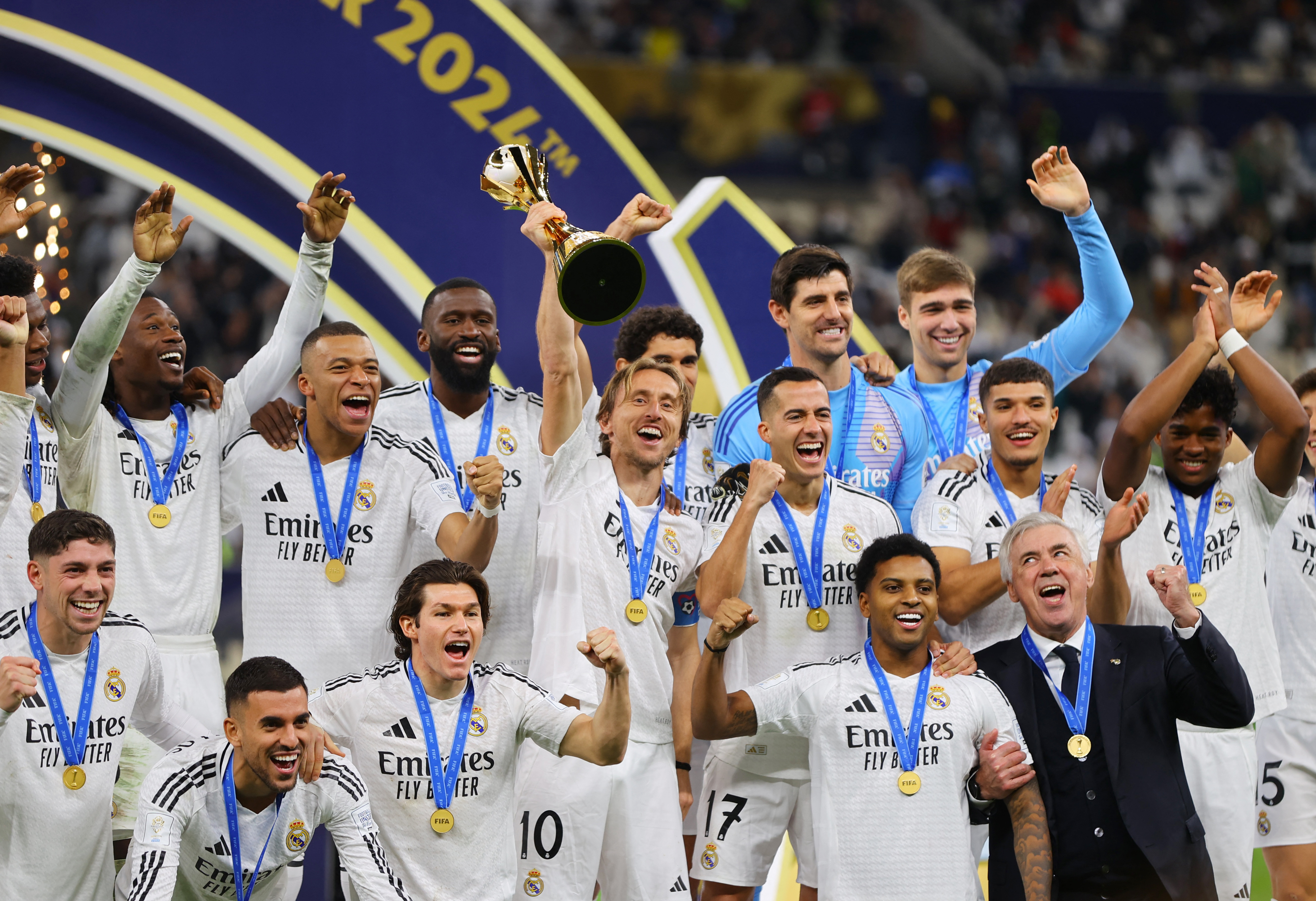 Soccer Football - Intercontinental Cup - Final - Real Madrid v Pachuca - Lusail Stadium, Lusail, Qatar - December 18, 2024 Real Madrid's Luka Modric lifts the trophy as he celebrates with teammates after winning the Intercontinental Cup REUTERS/Ibraheem Al Omari