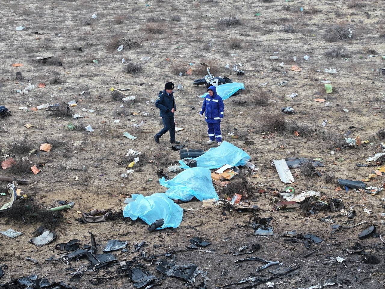 A drone view shows emergency specialists working at the crash site of an Azerbaijan Airlines passenger plane near the city of Aktau, Kazakhstan
