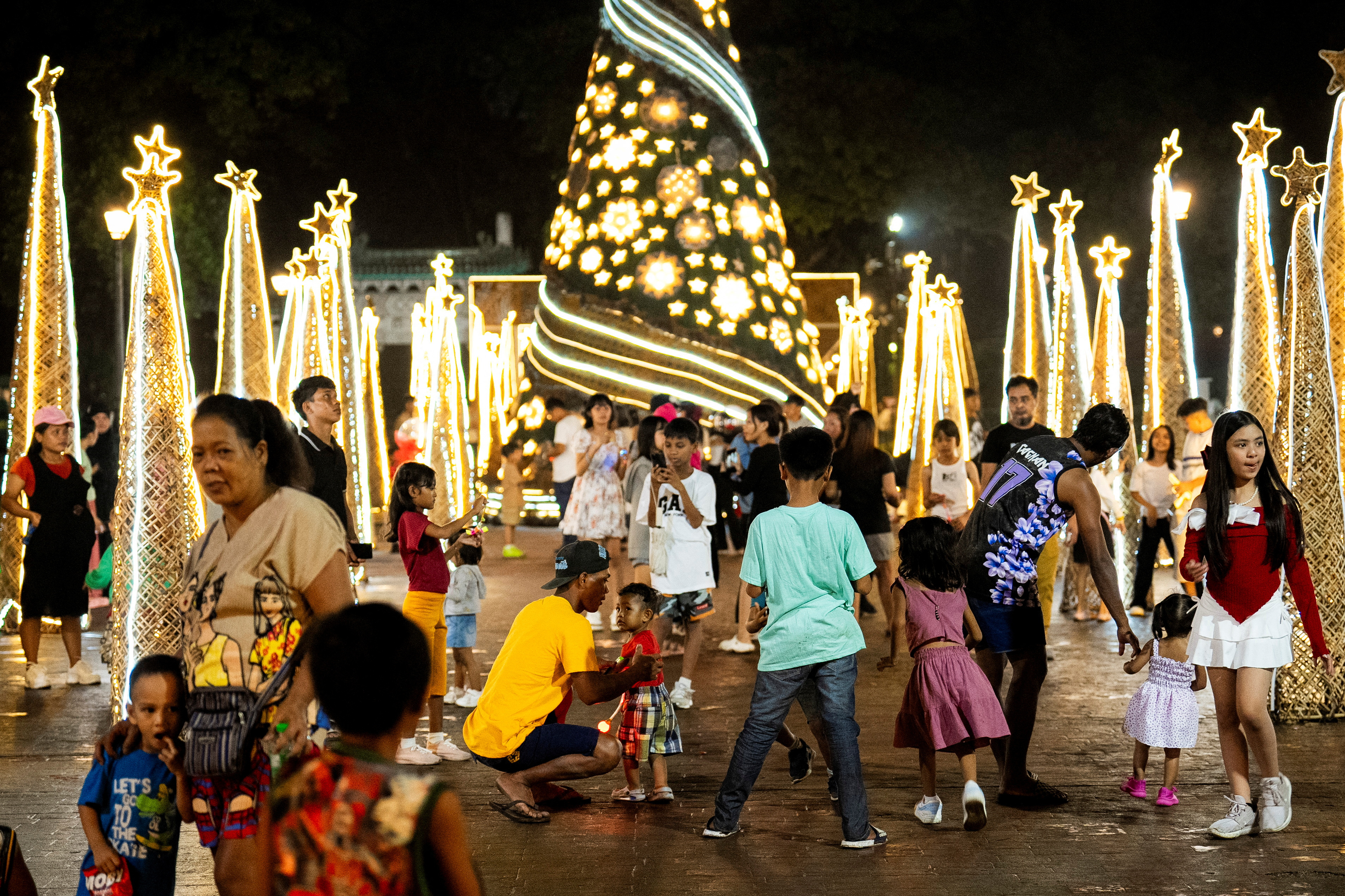 People visit Christmas tree displays as they celebrate Christmas at the Rizal Park in Manila, Philippines, December 25
