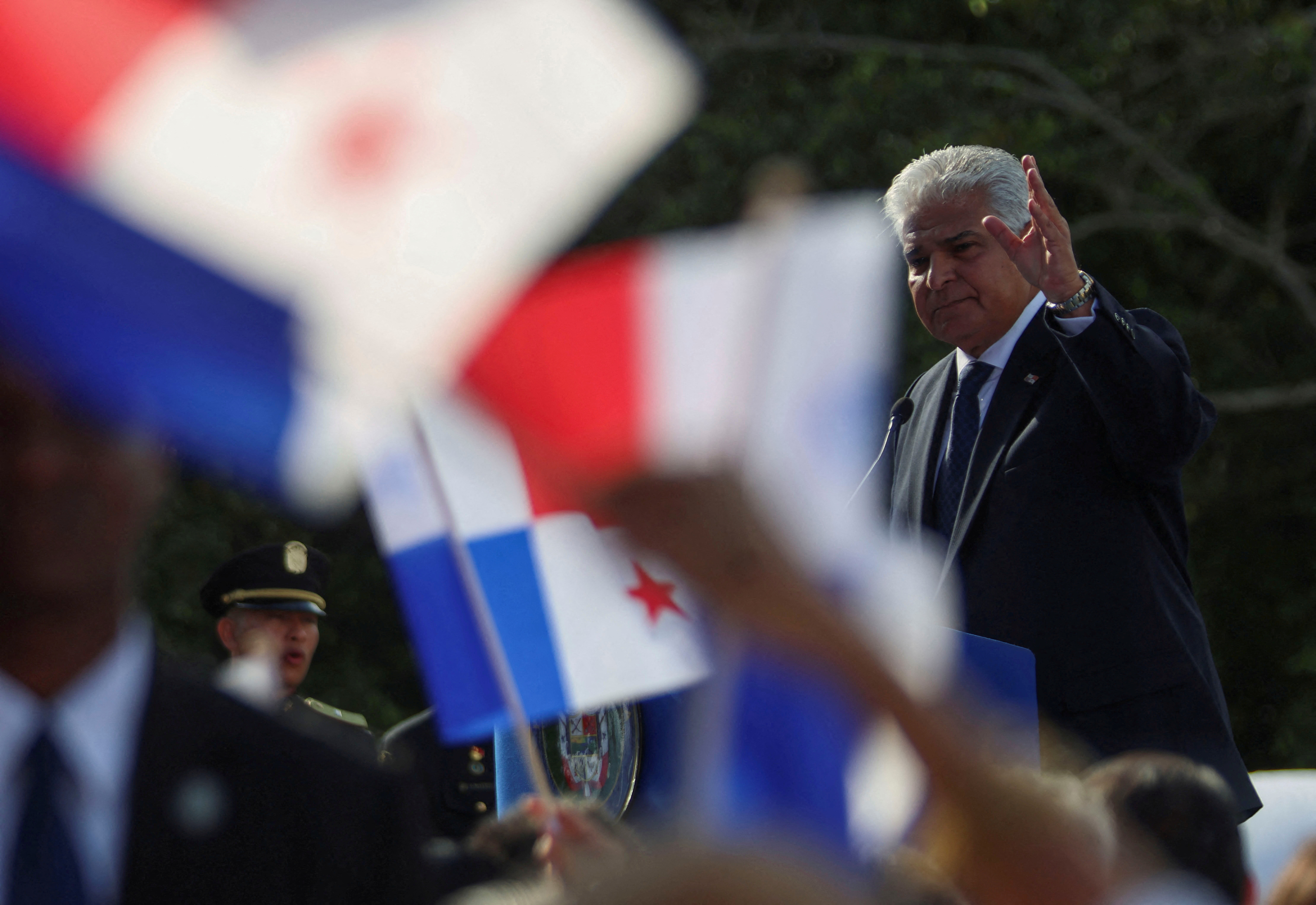 Jose Raul Molino, surrounded by Panamanian flags, attends a ceremony for the return of the Panama Canal