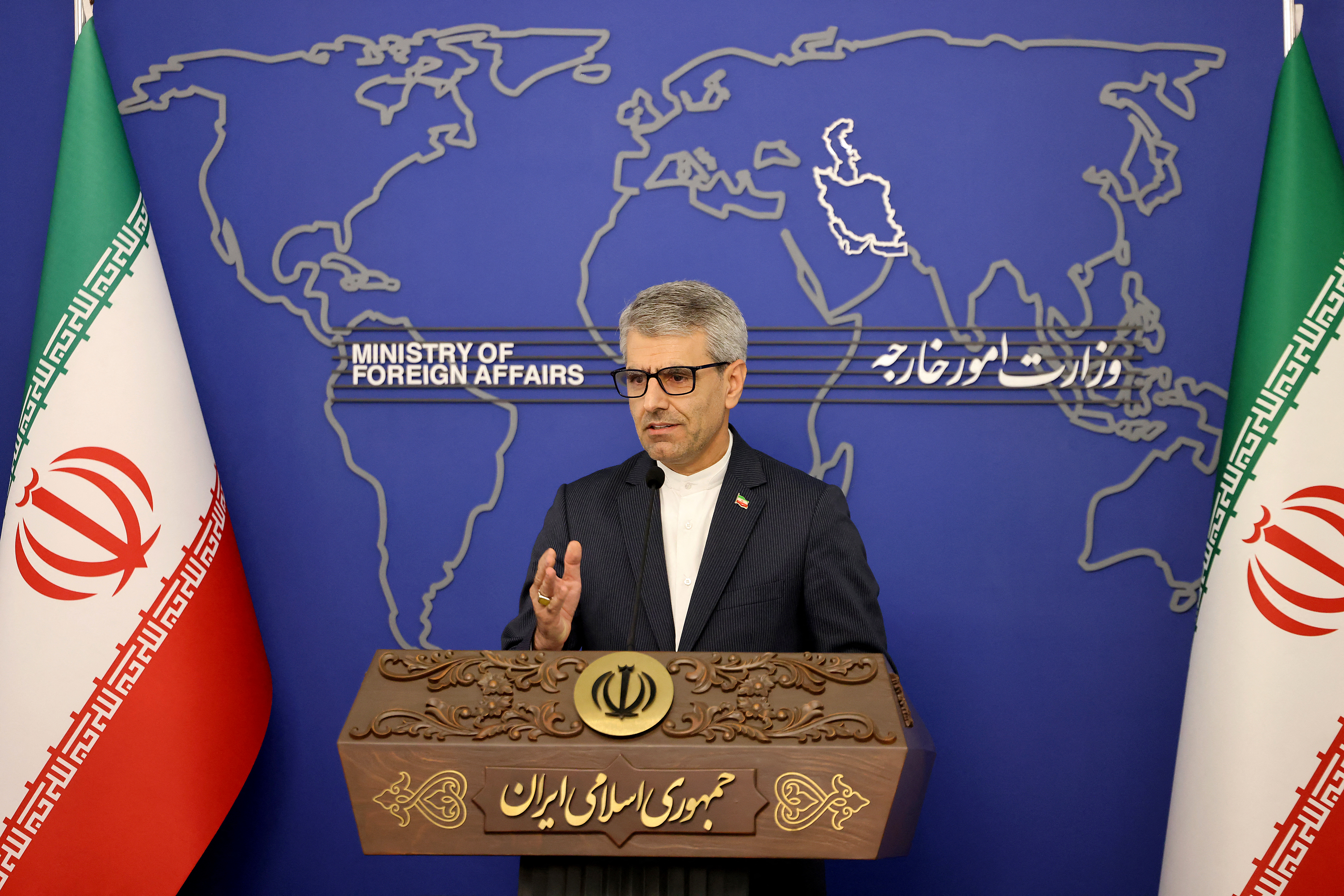 Iran's Foreign Ministry spokesman Esmaeil Baghaei speaking at a podium.
