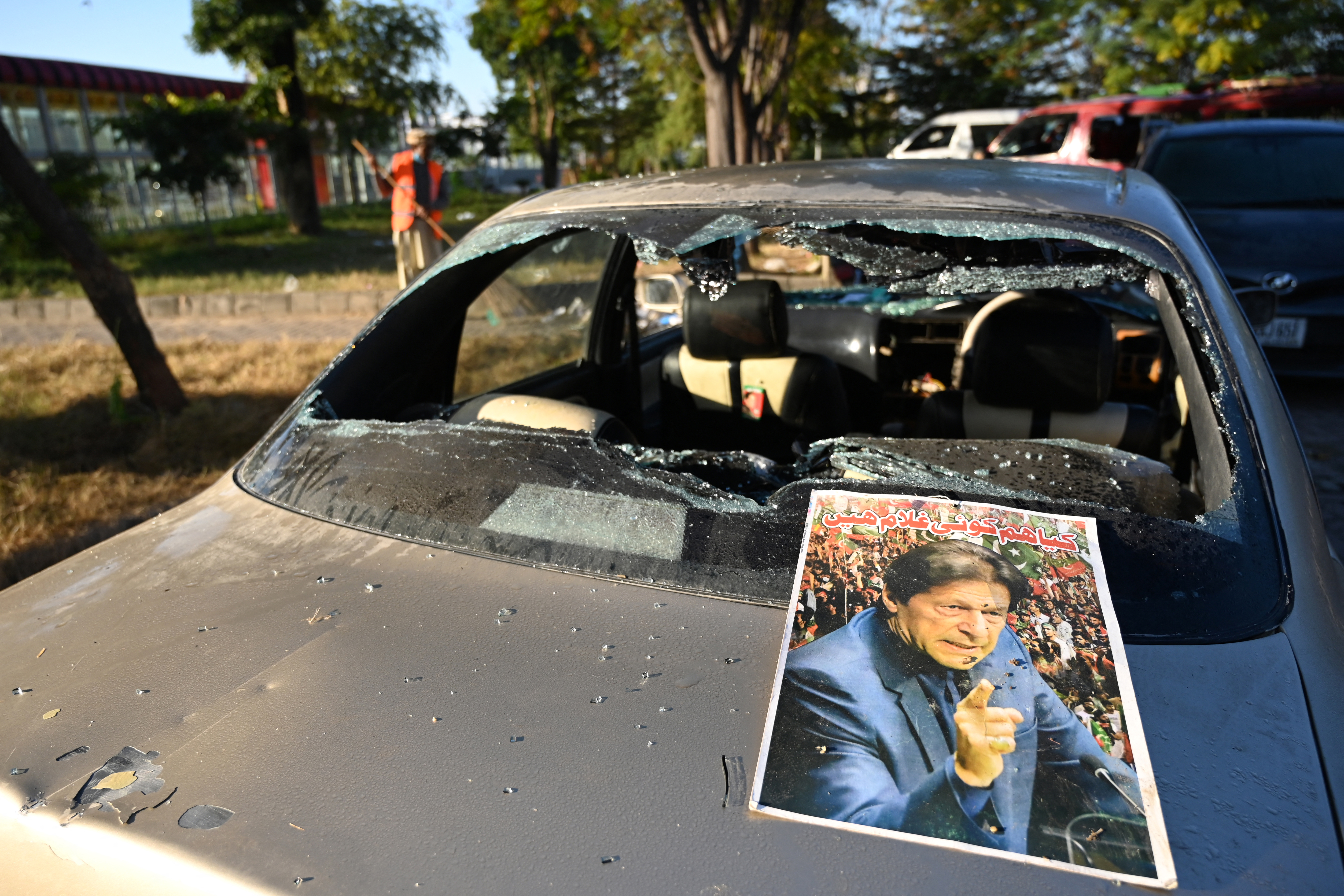 A poster of jailed former Pakistan's prime minister Imran Khan is pictured on a damaged vehicle after an overnight security forces operation against the supporters of Khan's Pakistan Tehreek-e-Insaf (PTI) party in Islamabad on November 27, 2024. - Protesters who marched on the Pakistan capital to demand the release of jailed former prime minister Imran Khan were cleared from the city centre on November 27 after a sweeping security crackdown. (Photo by Aamir QURESHI / AFP)