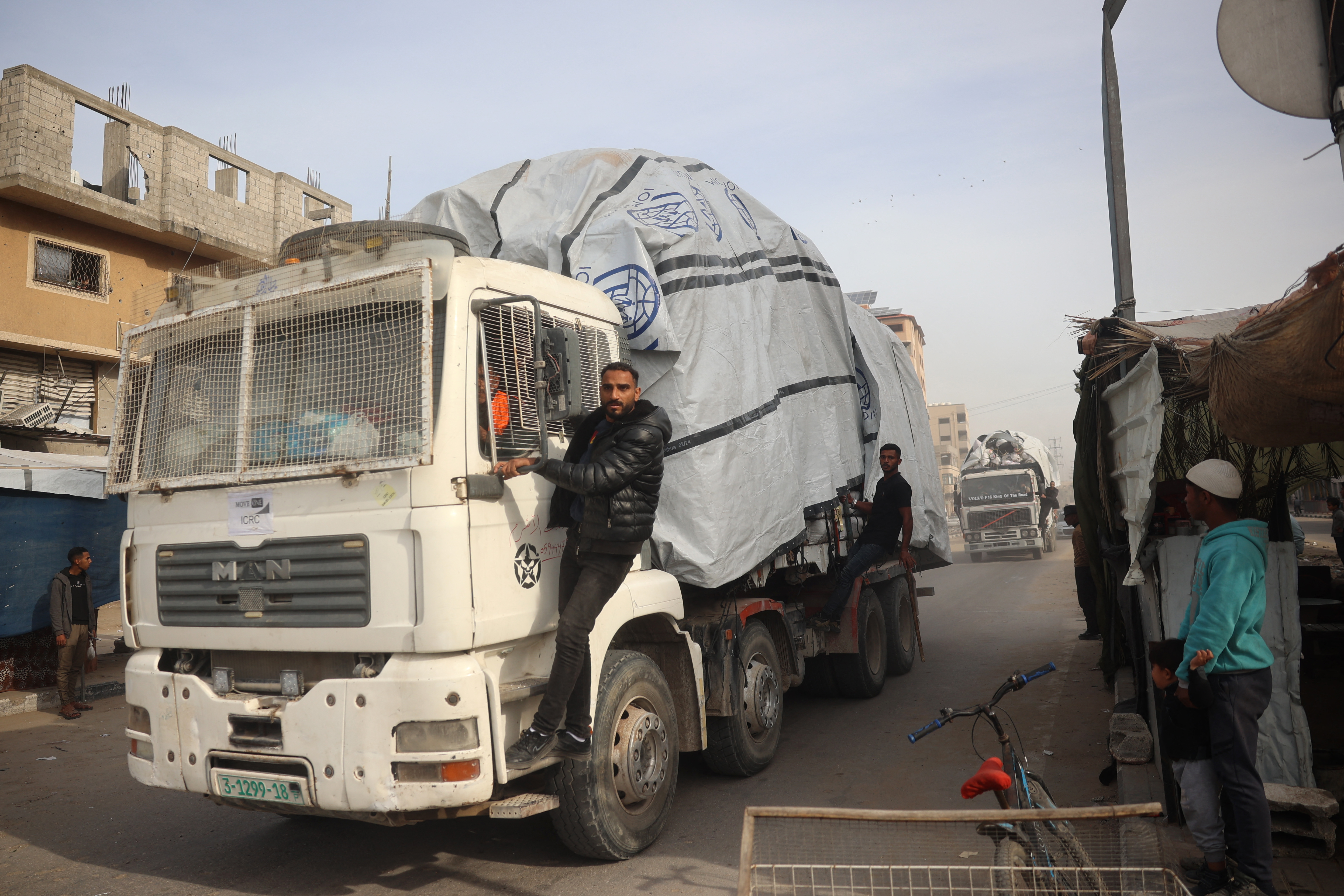 A truck carrying humanitarian aid drives on the main Salah al-Din Street in the Nuseirat refugee Camp in the central Gaza Strip on Wednesday [Eyad Baba/AFP]