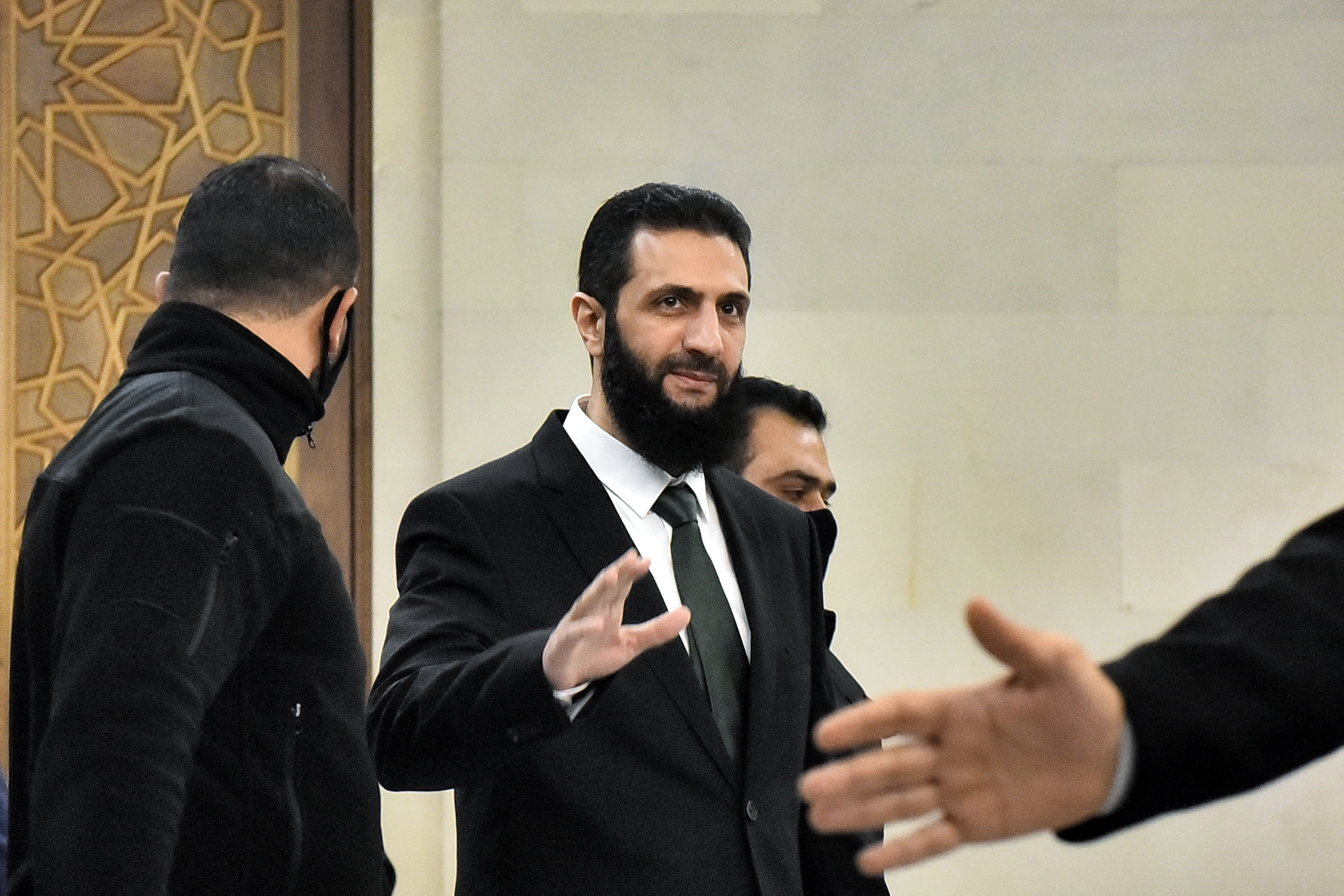 Hayat Tahrir al-Sham (HTS) leader Ahmed al-Sharaa (also known as Abu Mohammad al-Jolani) arrives for a meeing with visiting Druze officials from Lebanon's Progressive Socialist Party (PSP) in Damascus on December 22, 2024. - PSP former leader Walid Jumblatt is the first Lebanese leader to meet Sharaa since his Islamist group Hayat Tahrir al-Sham (HTS) and allied rebel factions launched a lightning offensive last month, seizing Damascus on December 8 and ousting longtime ruler Bashar al-Assad. (Photo by AFP)