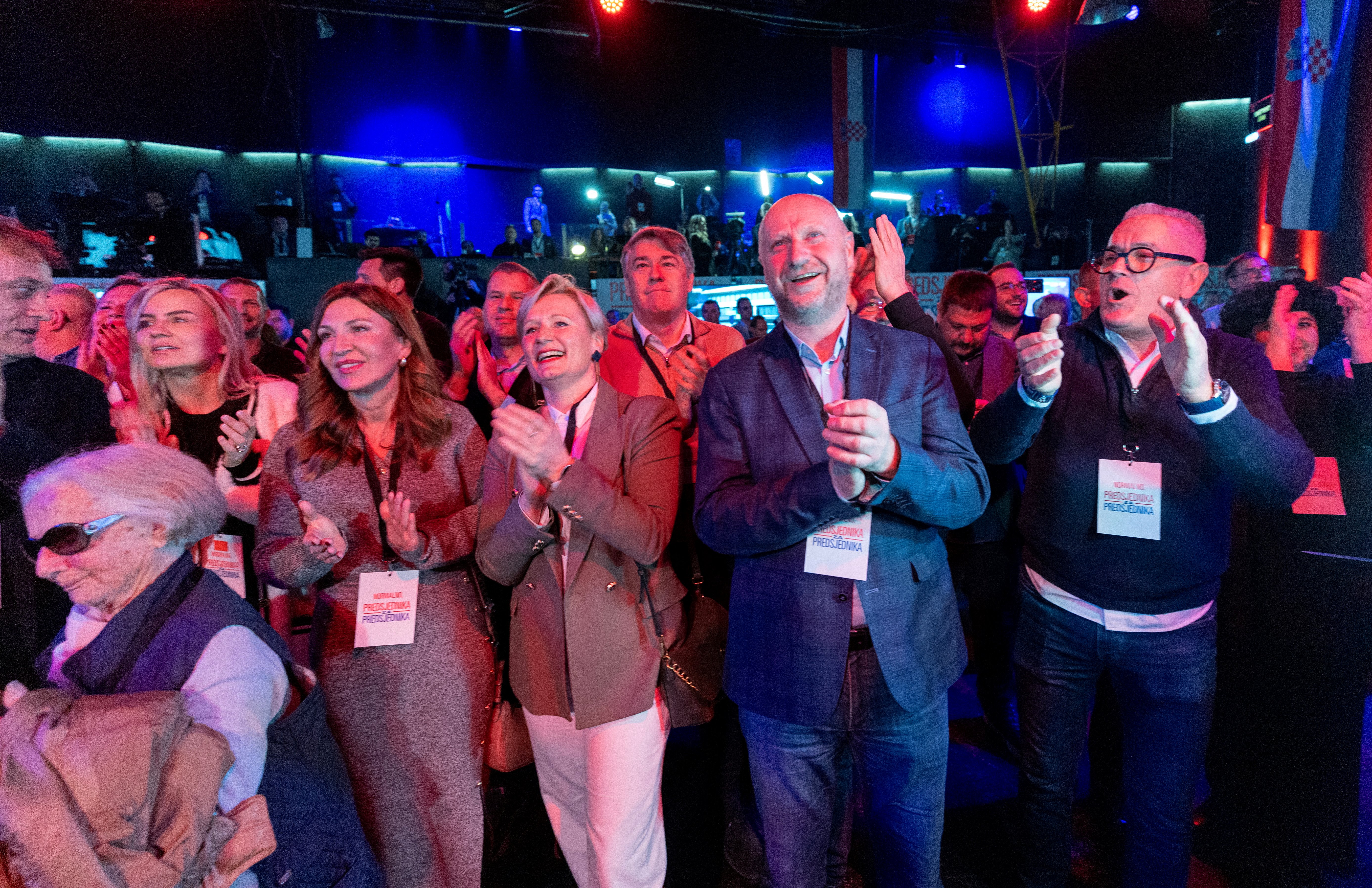 Supporters of Croatia's outgoing President and Social Democratic Party (SDP) presidential candidate Zoran Milanovic celebrate after the first exit poll results at the candidate's headquarters in Zagreb, Croatia, on December 29, 2024. - Croatia's incumbent President, backed by the opposition left-wing Social Democrats, won the presidential election in the first round, according to an exit poll. (Photo by DAMIR SENCAR / AFP)